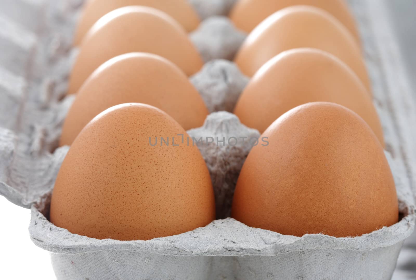 fresh whole brown eggs on container