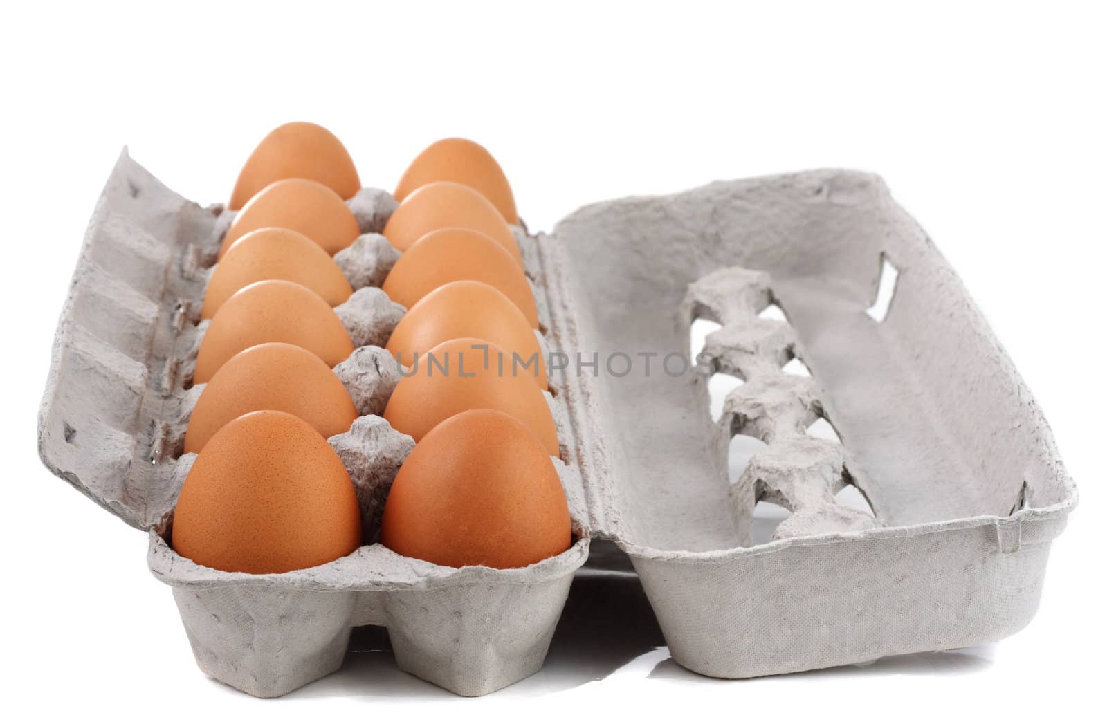 dozen of fresh brown eggs on container