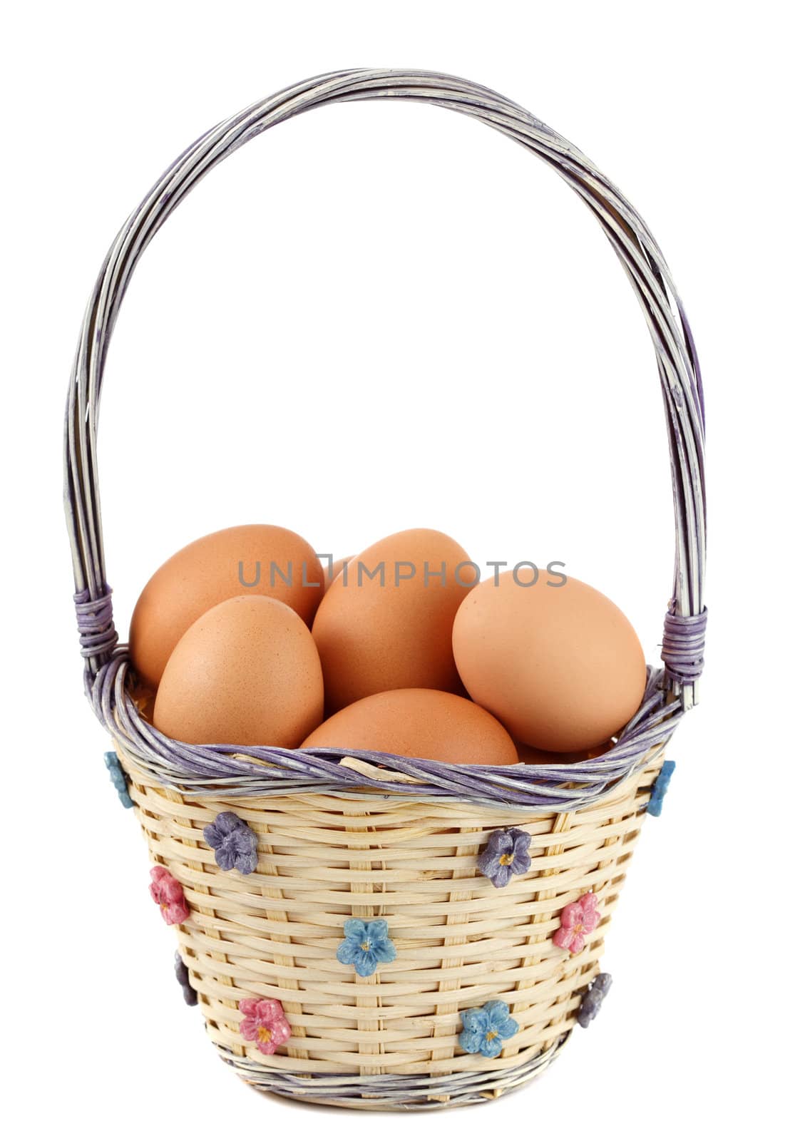 fresh whole brown eggs on wicker basket, white background