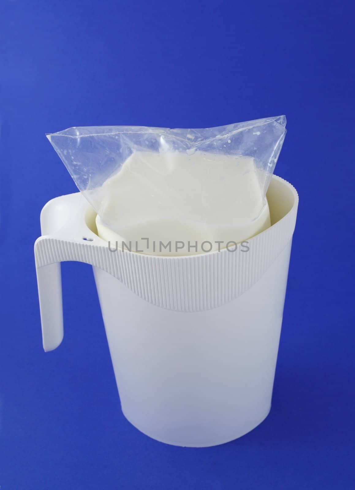 white milk pitcher, blue background