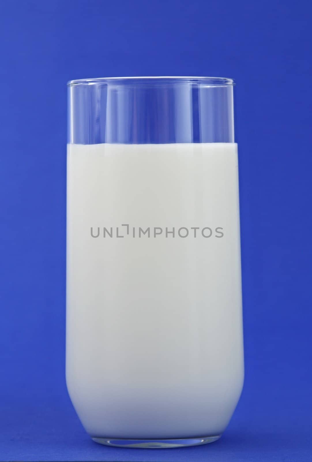 glass of milk, blue background