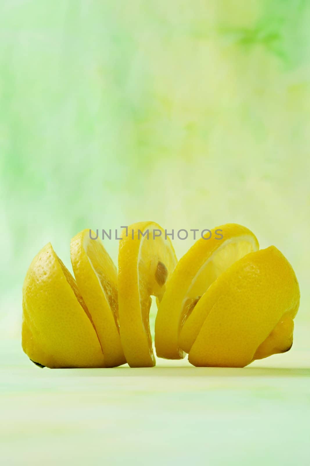 sliced fresh lemon, green background