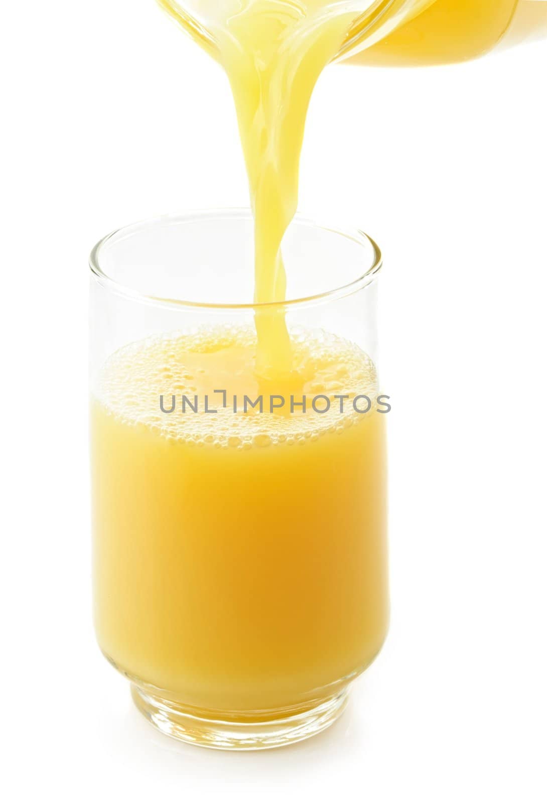 pouring orange juice in a glass, isolated on white