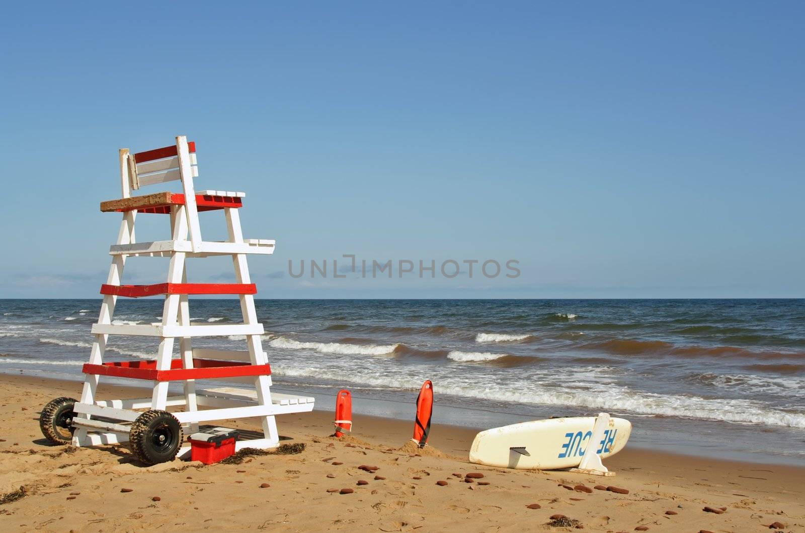 lifeguard chair and beach rescue tools on ocean shore