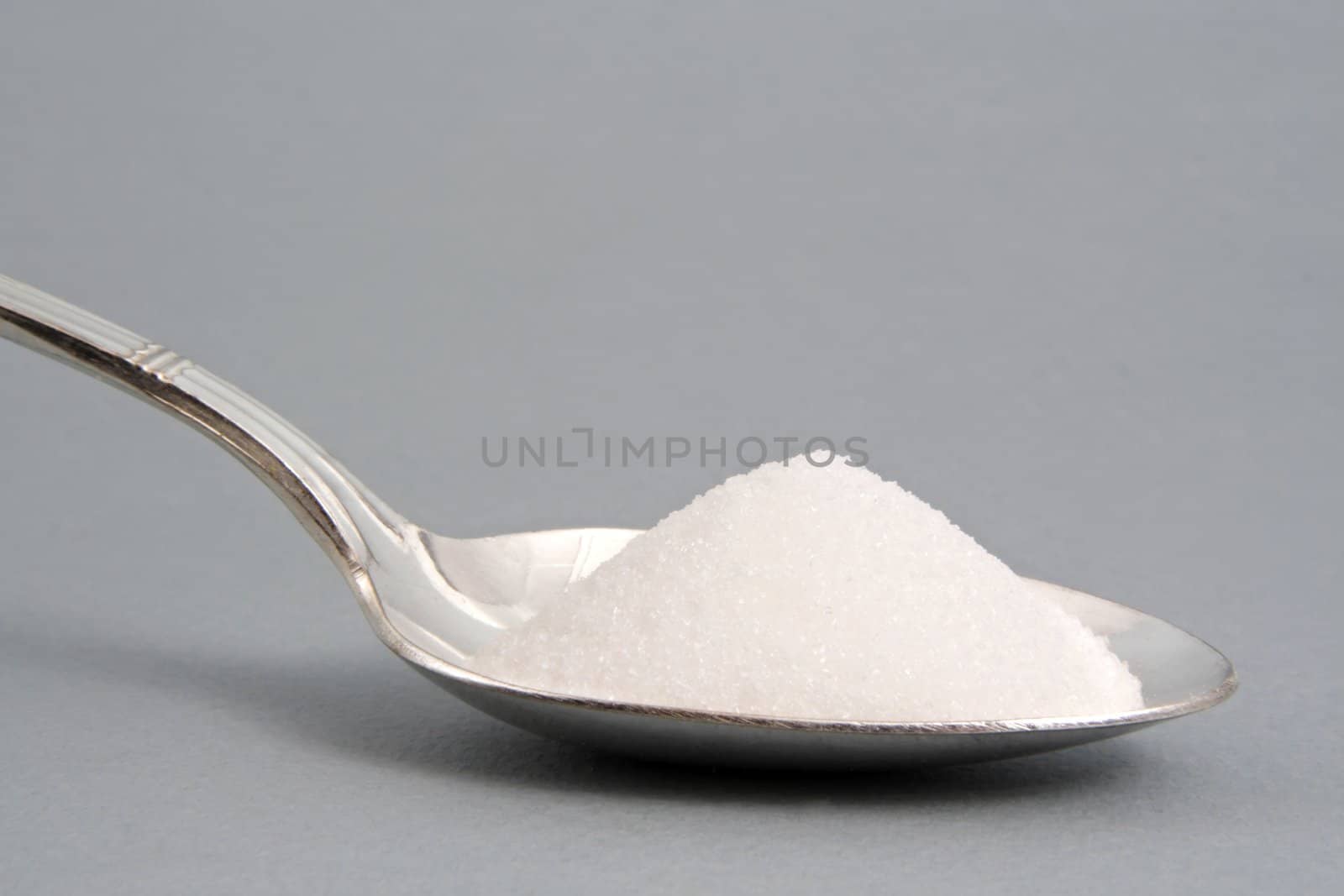 sugar in a silver spoon,