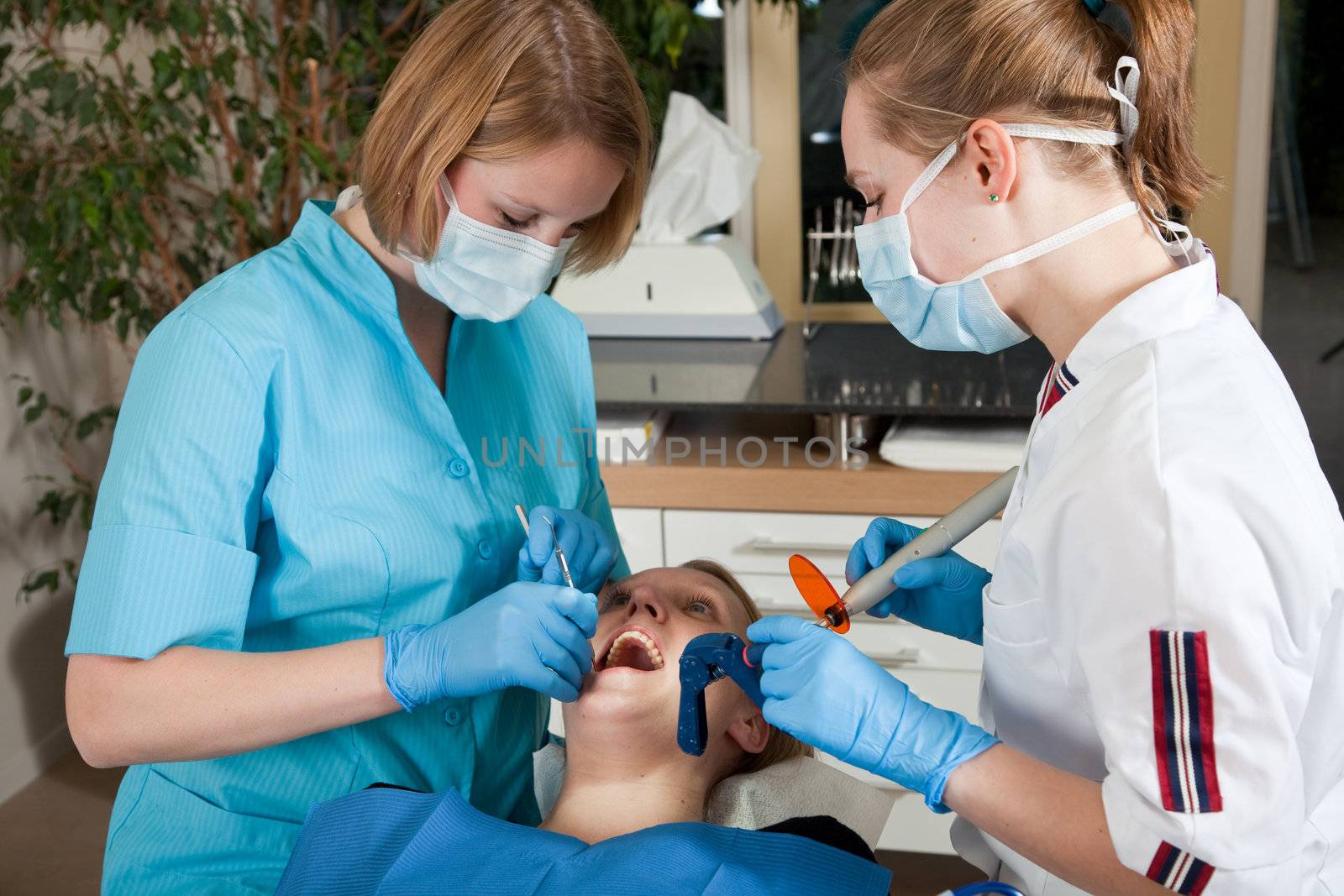 Female dentist preparing to fill the cavities