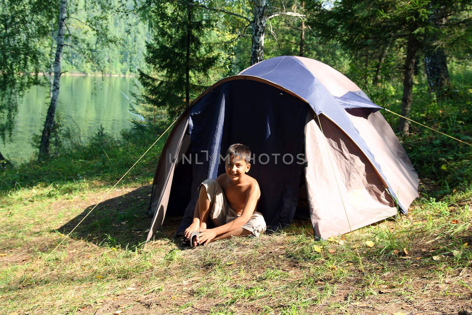 smiling boy near tent by Mikko