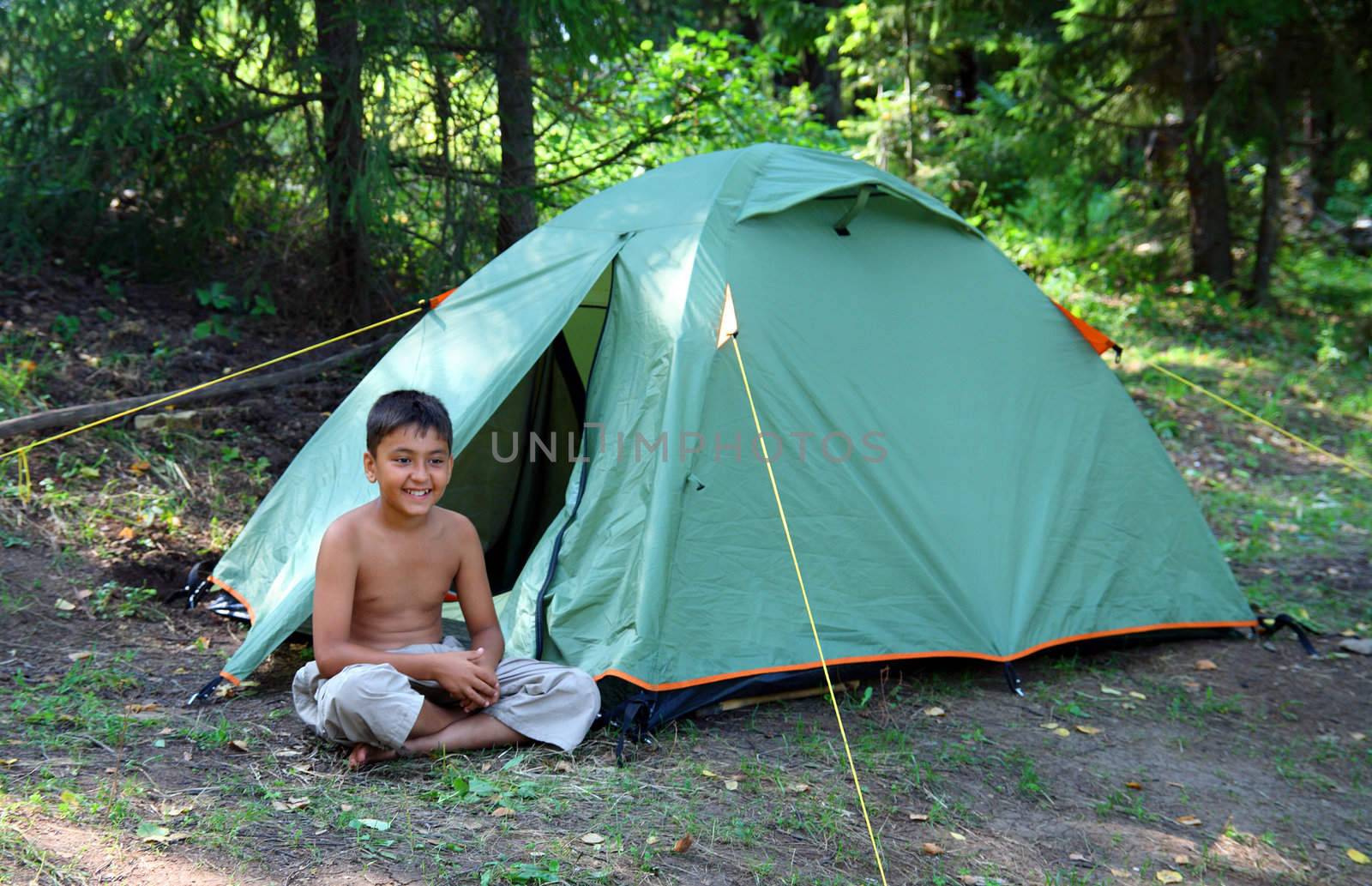 smiling boy near tent by Mikko