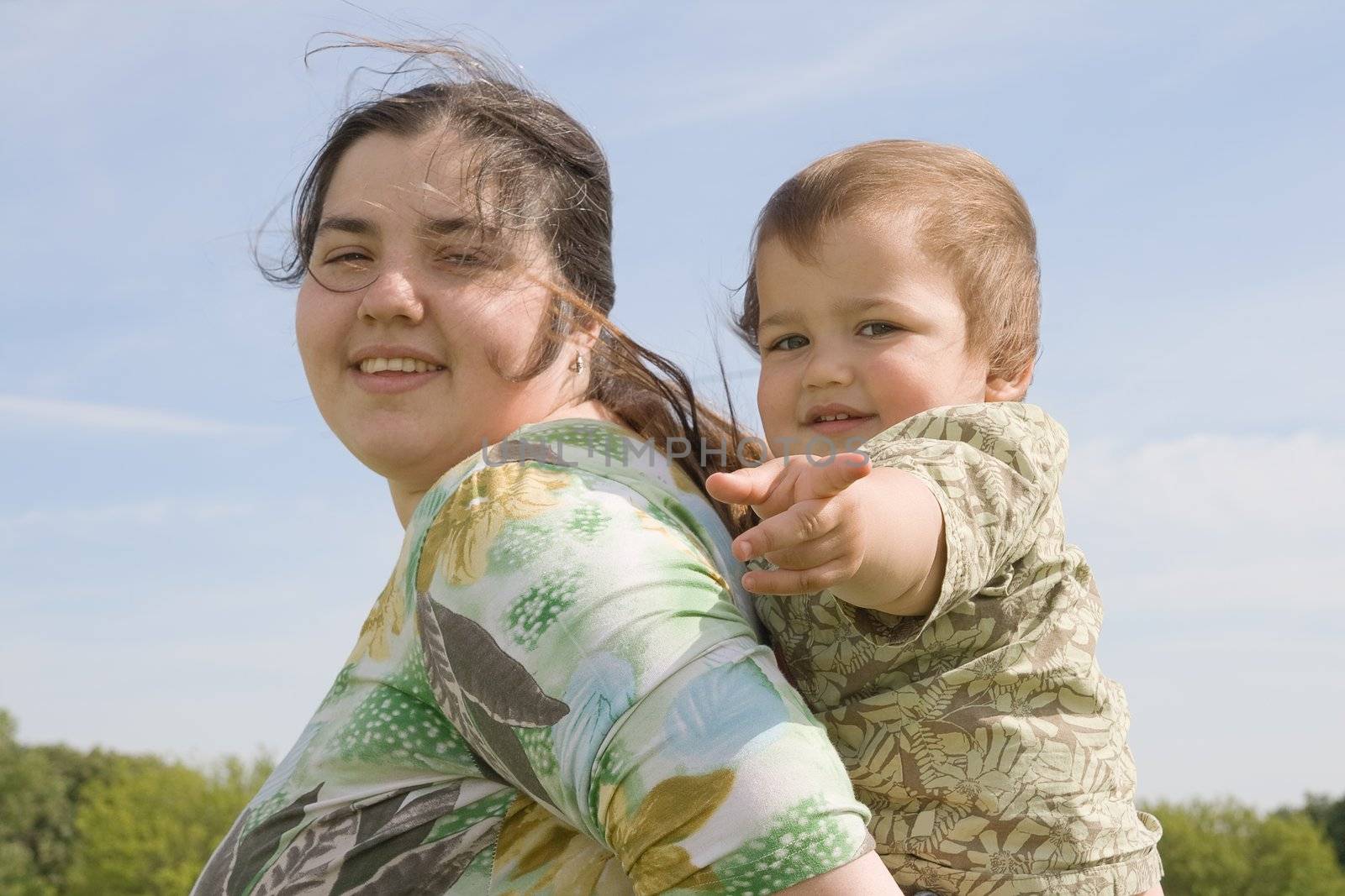 Woman holding her little child on back