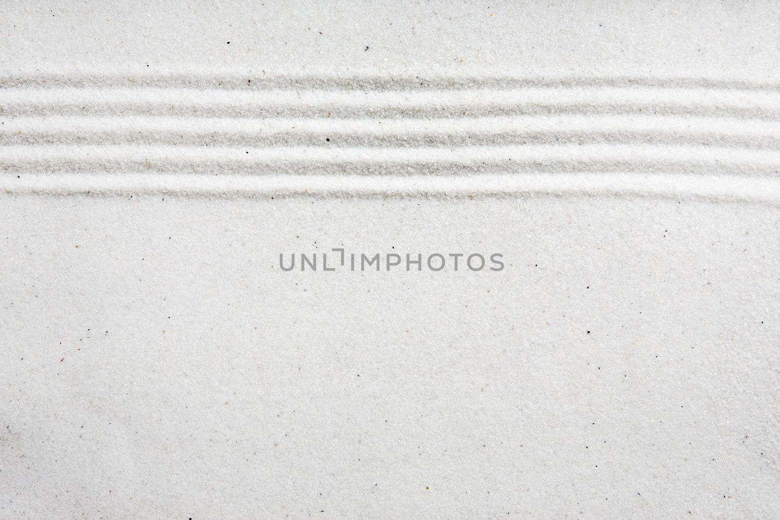 A background image with white sand and a raked stripe