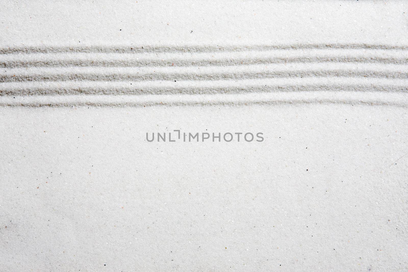 A background image with white sand and a raked stripe