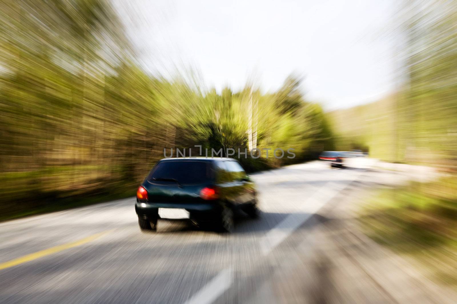 A motion blur image of a speeding car