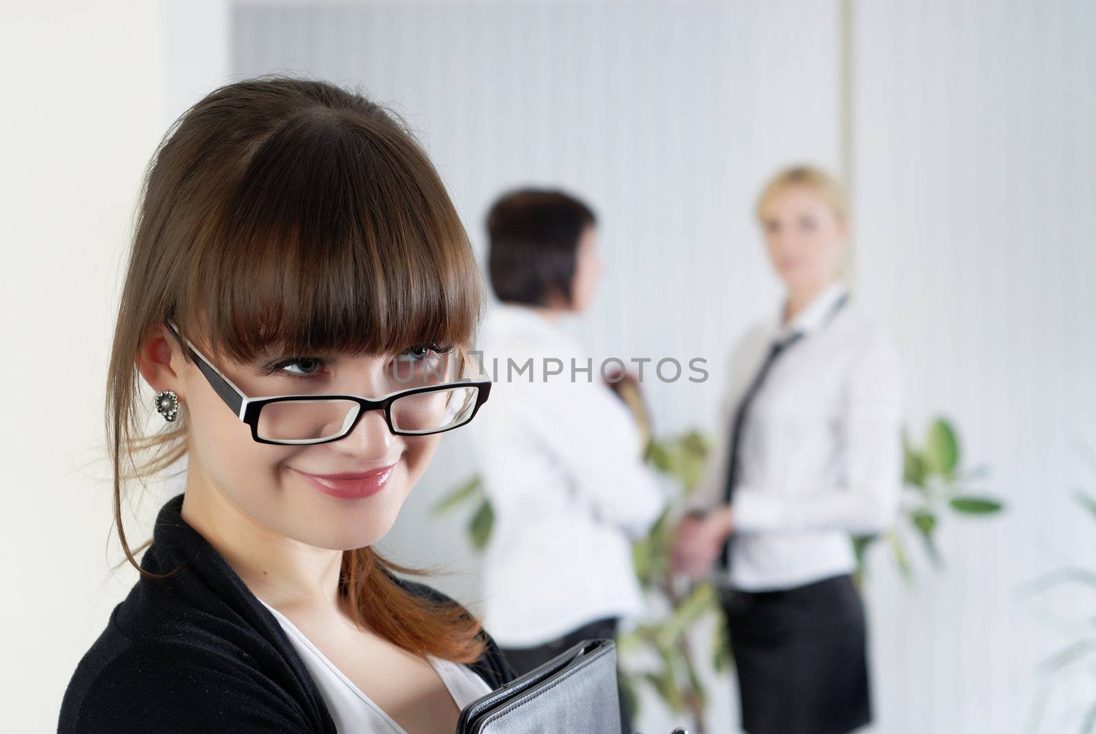  The young business woman at office with colleagues 

