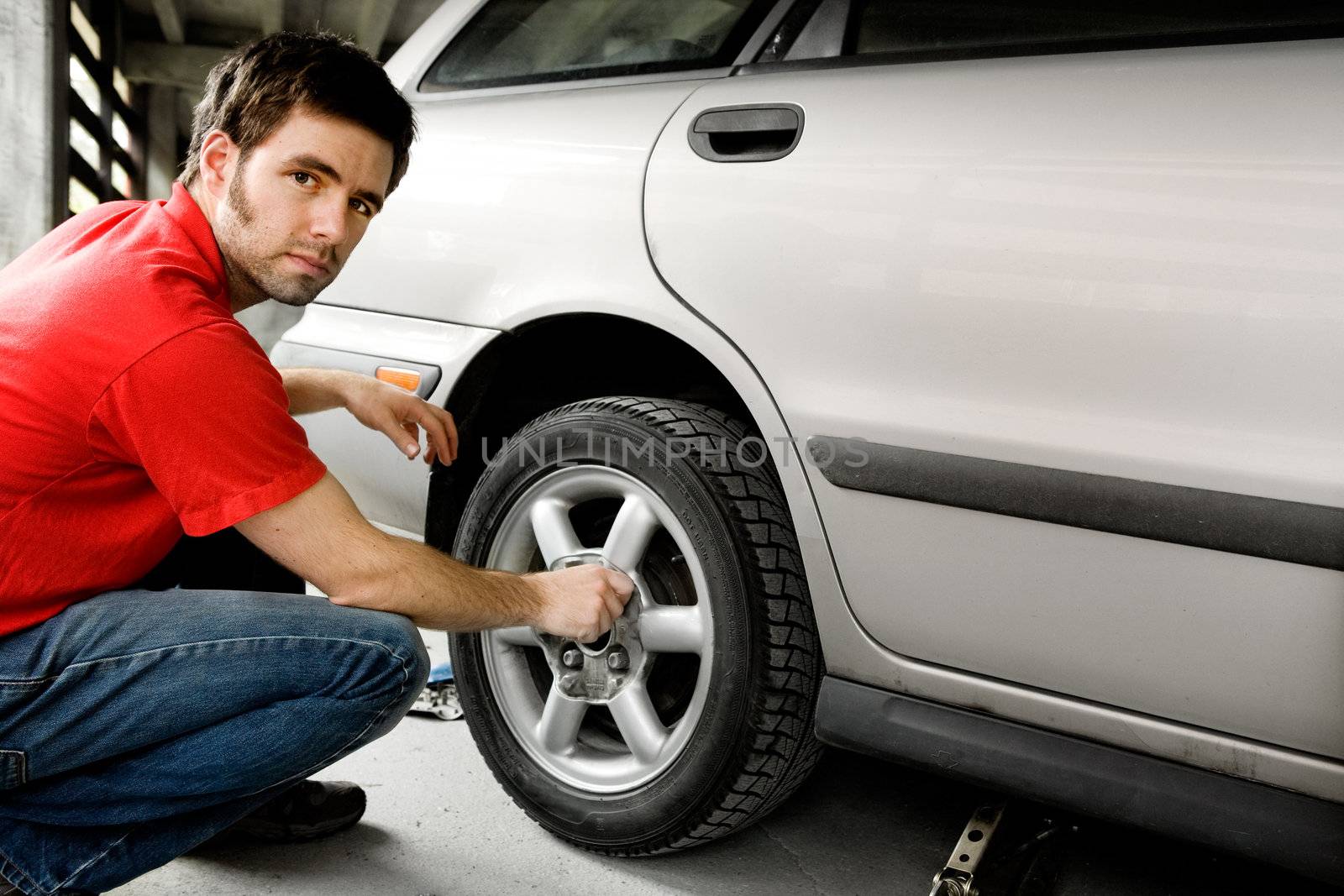 Male Changing Tire by leaf