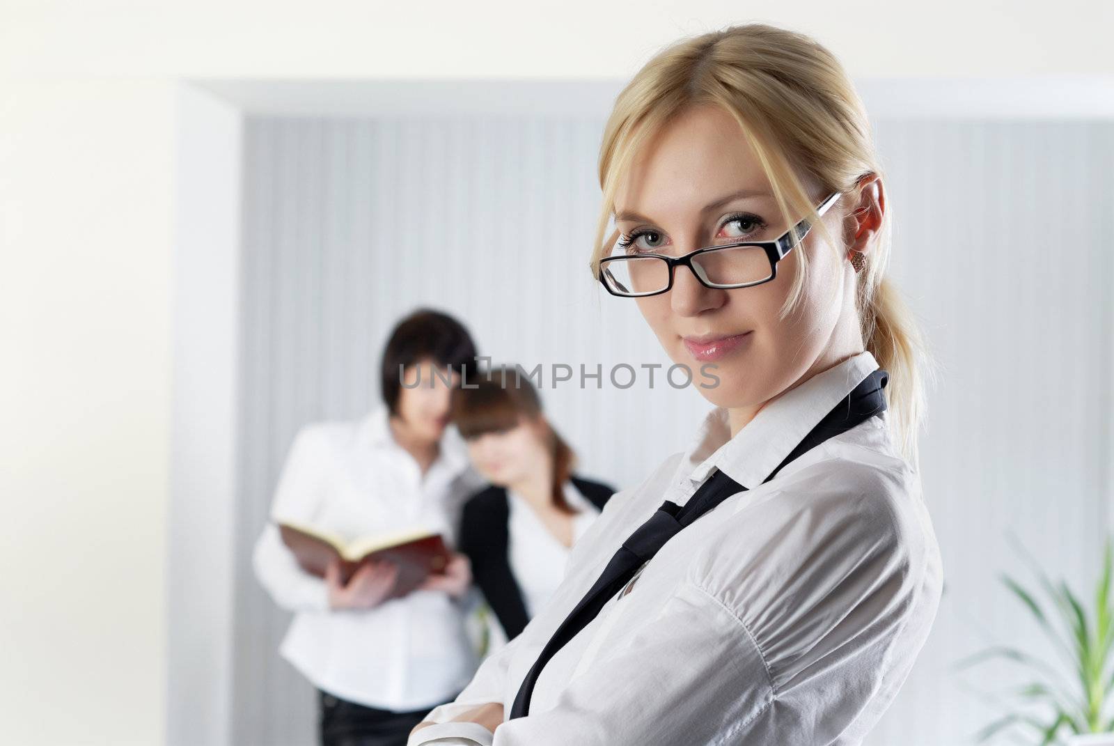  The young business woman at office with colleagues  by Baronerosso