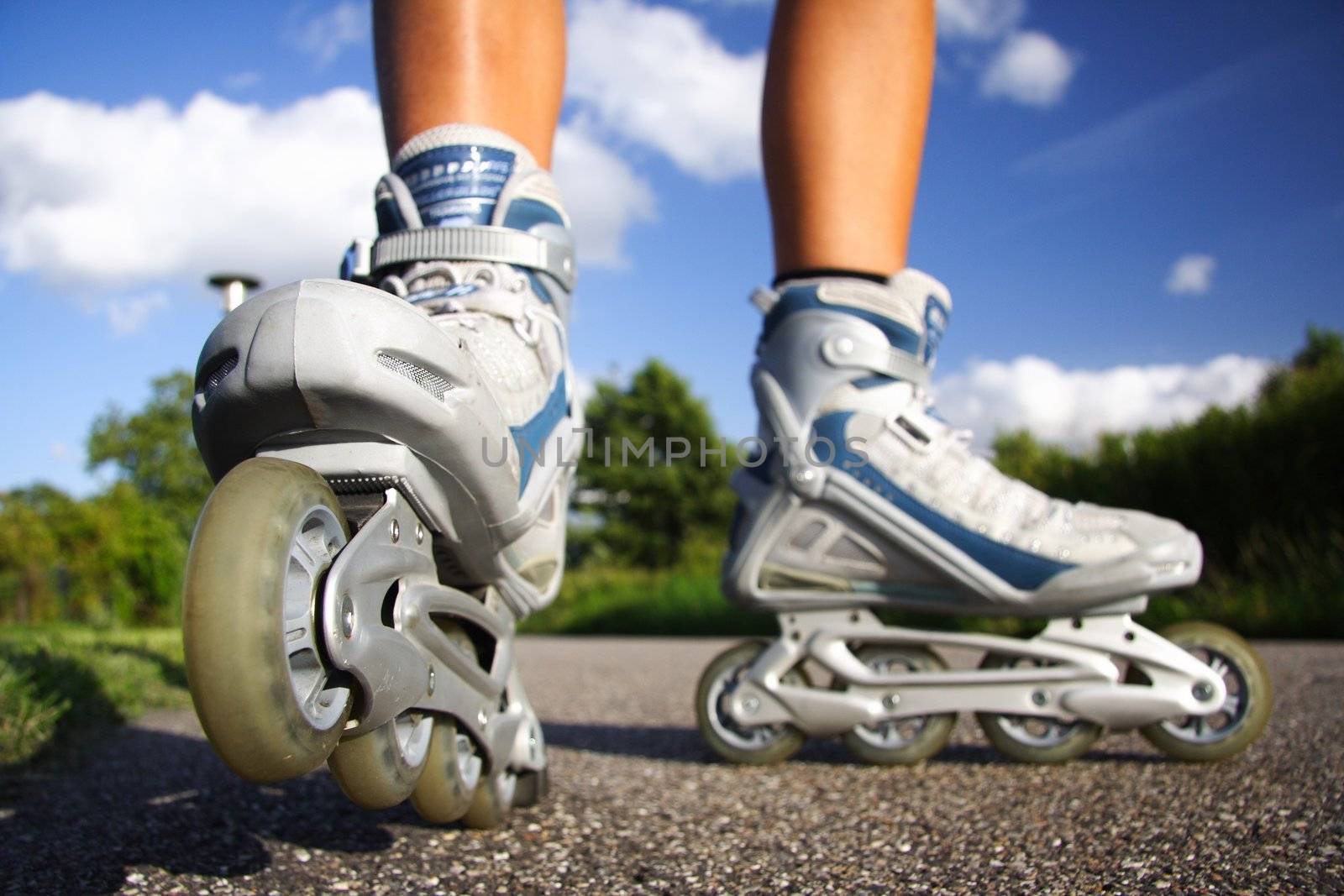 Inline skates in action closeup. Shallow depth of field, focus on left skate.