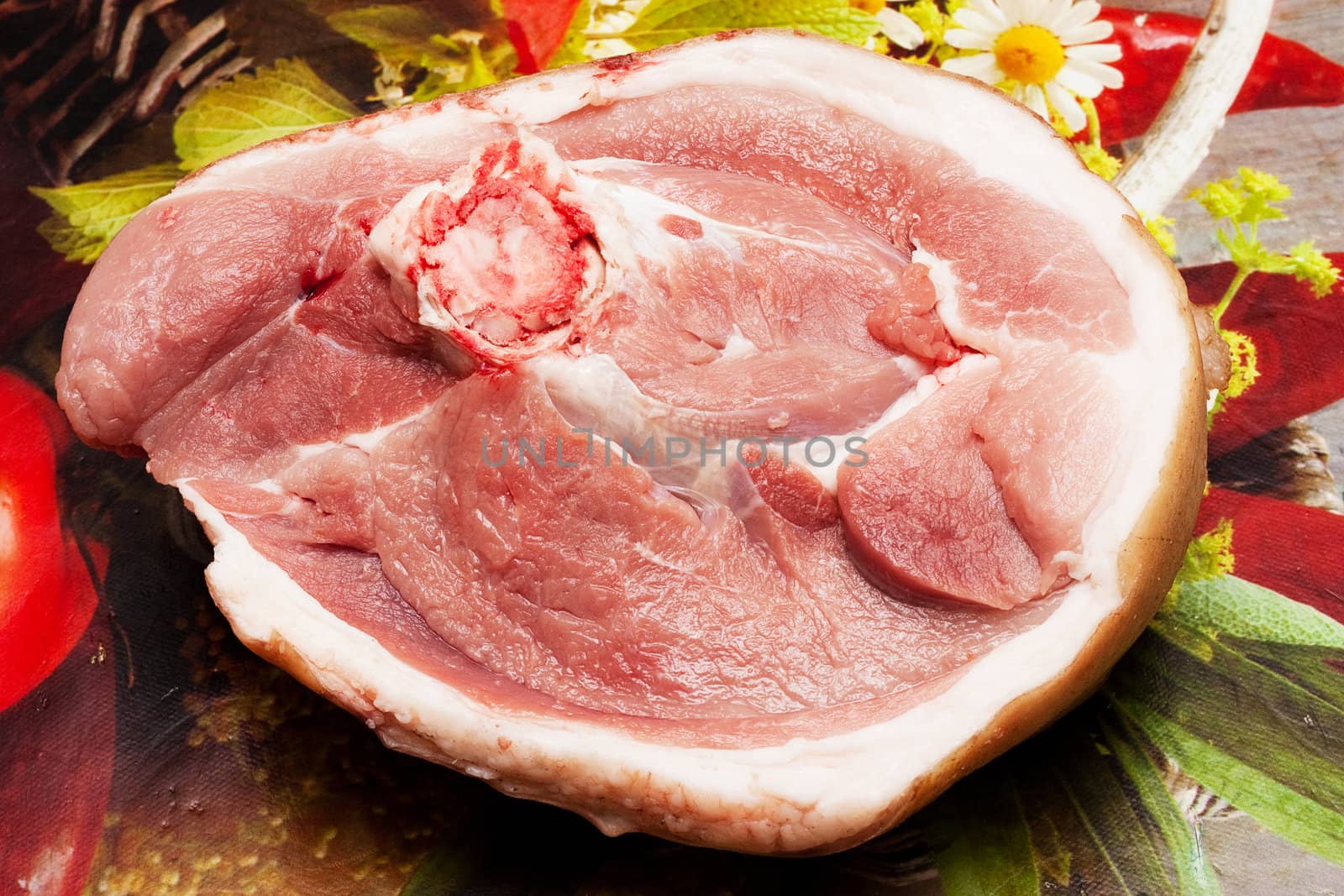 A piece of raw meat at a plural background