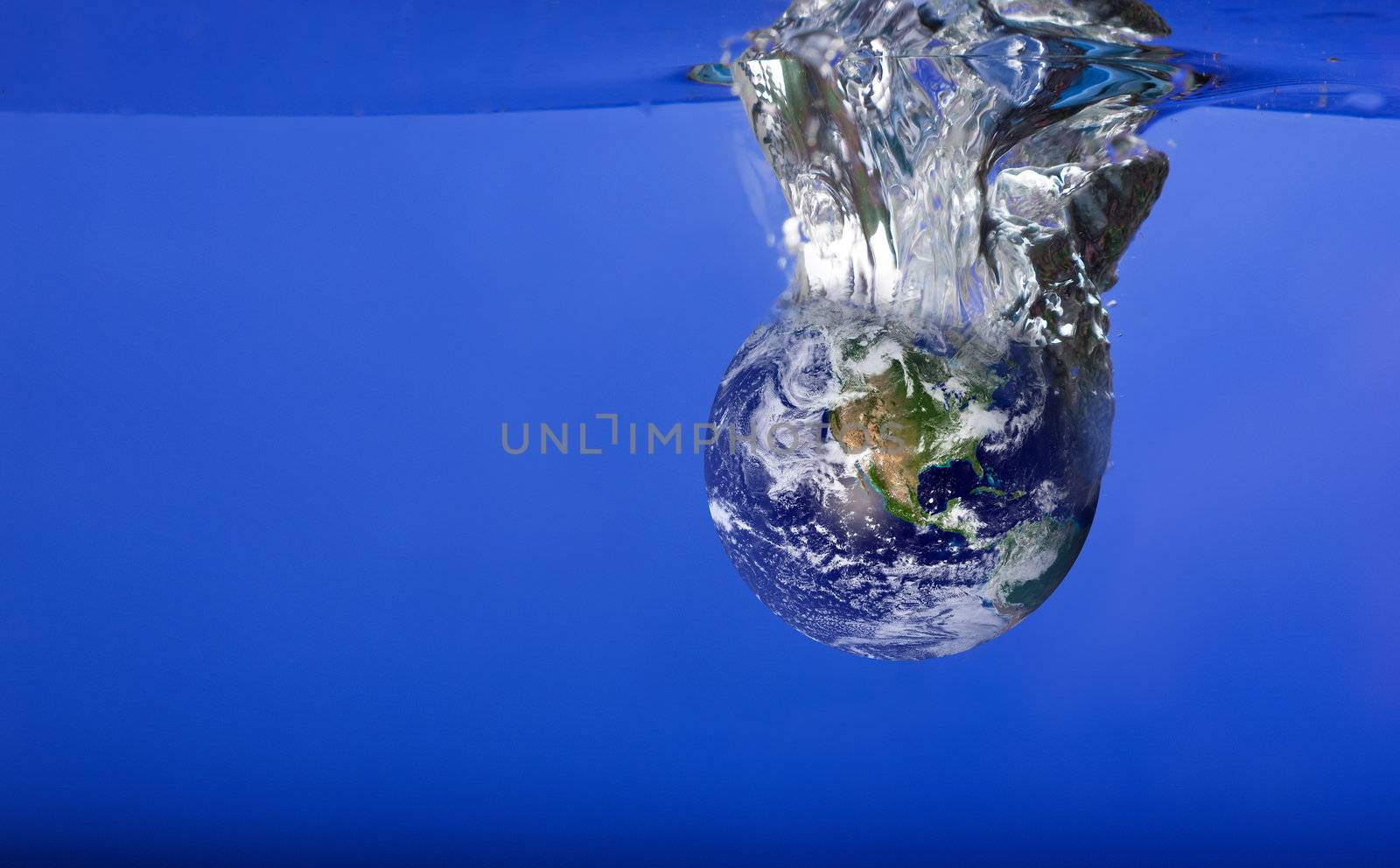 A globe sinking in water with bubbles