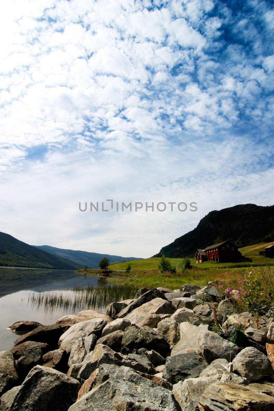 A norwegian fjord landscape with dramatic sky