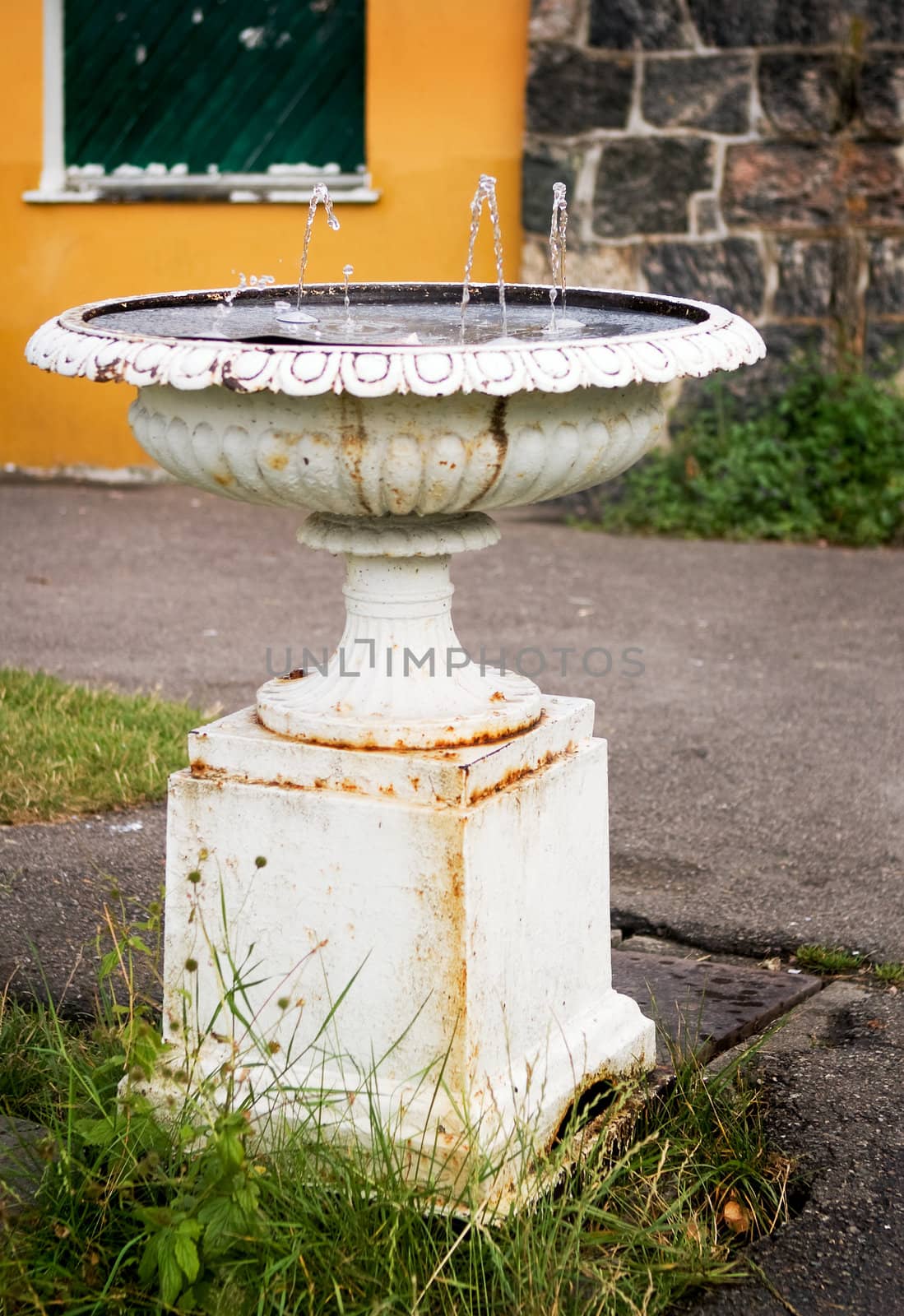 An old waterfountain in a urban area