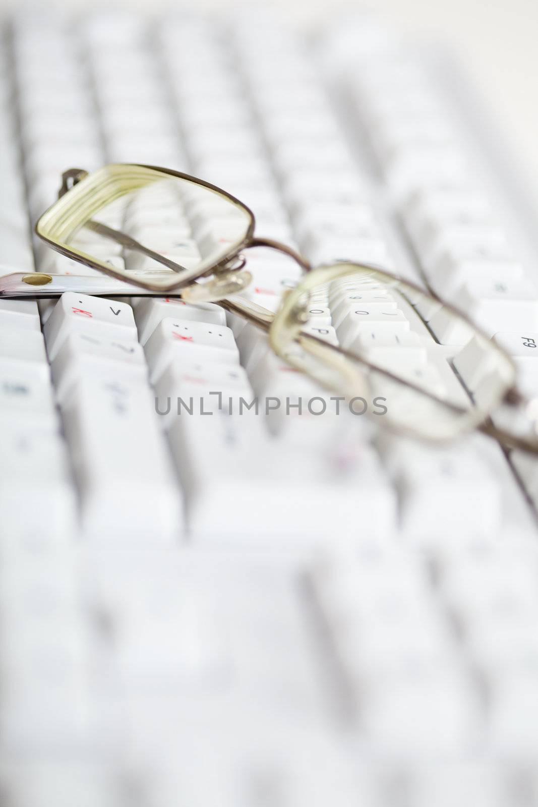 Spectacles are on the computer keyboard - poor eyesight
