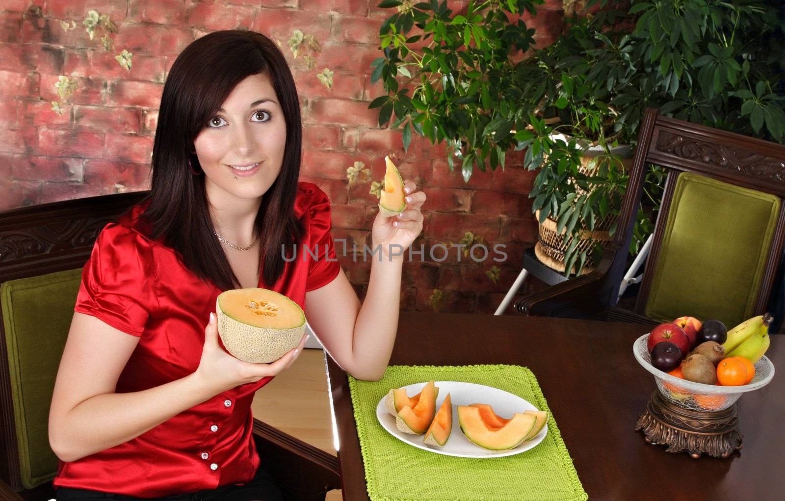 young woman holding a cantaloupe