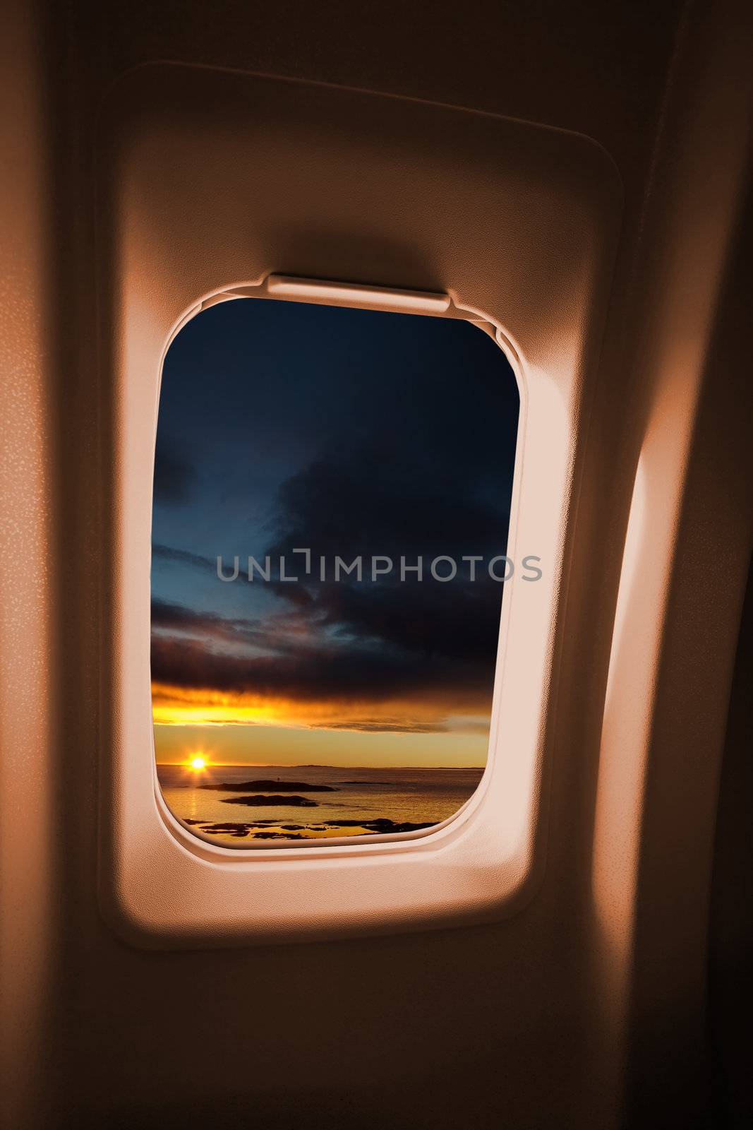 A sunset landscape from an airplane window.