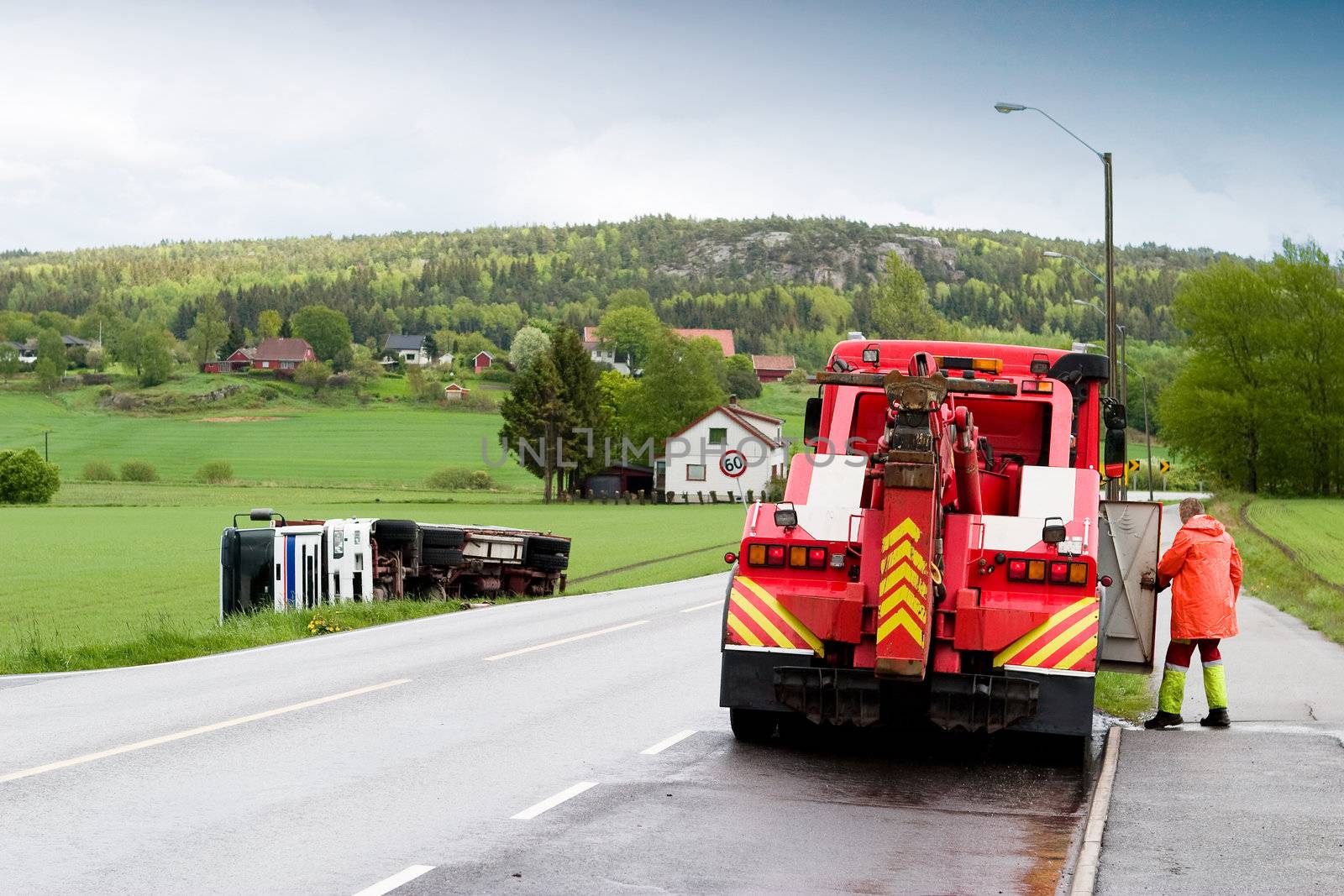 A tow truck arrives on the scene of an accident