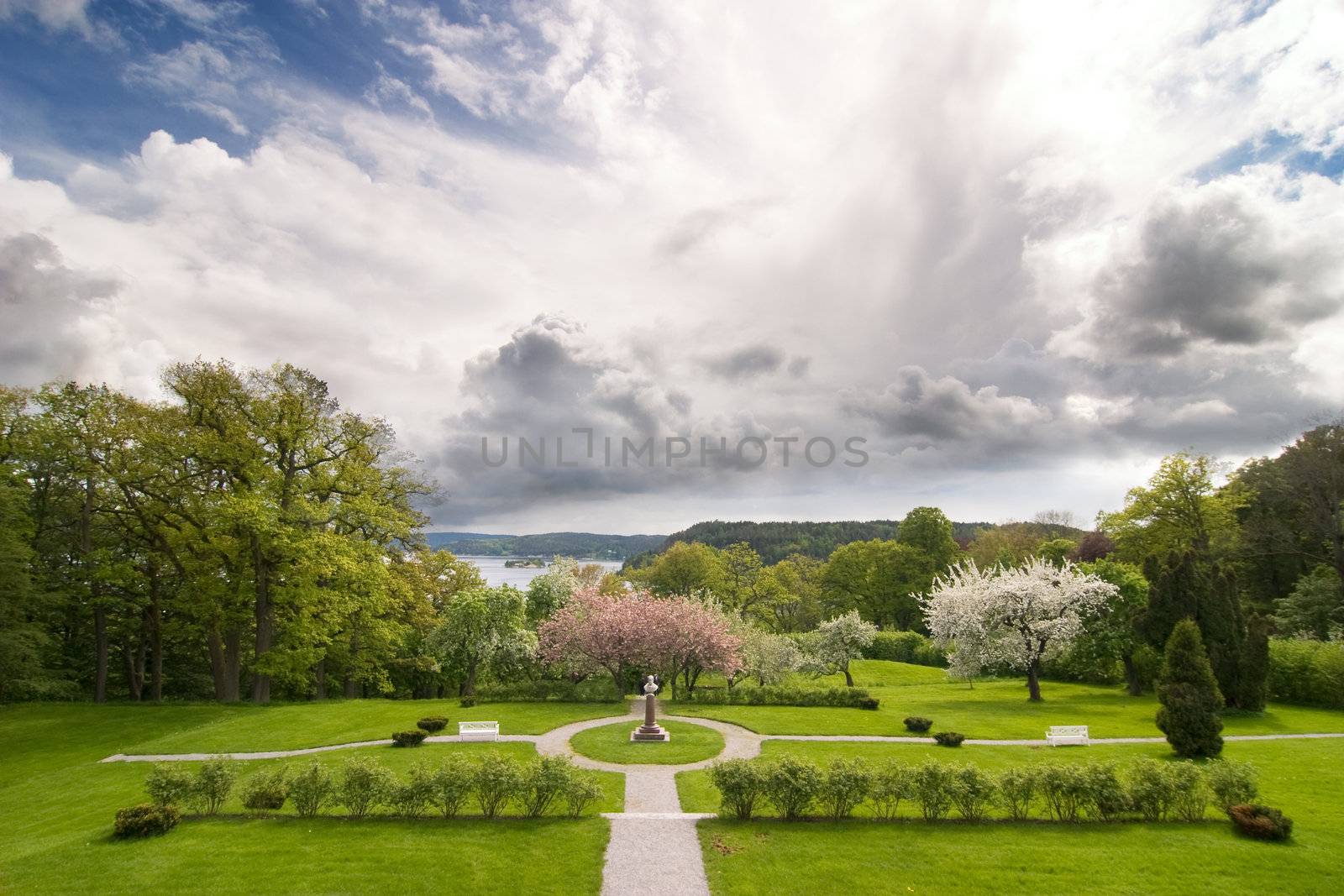 A beautiful park or garden with a dramatic sky in the background