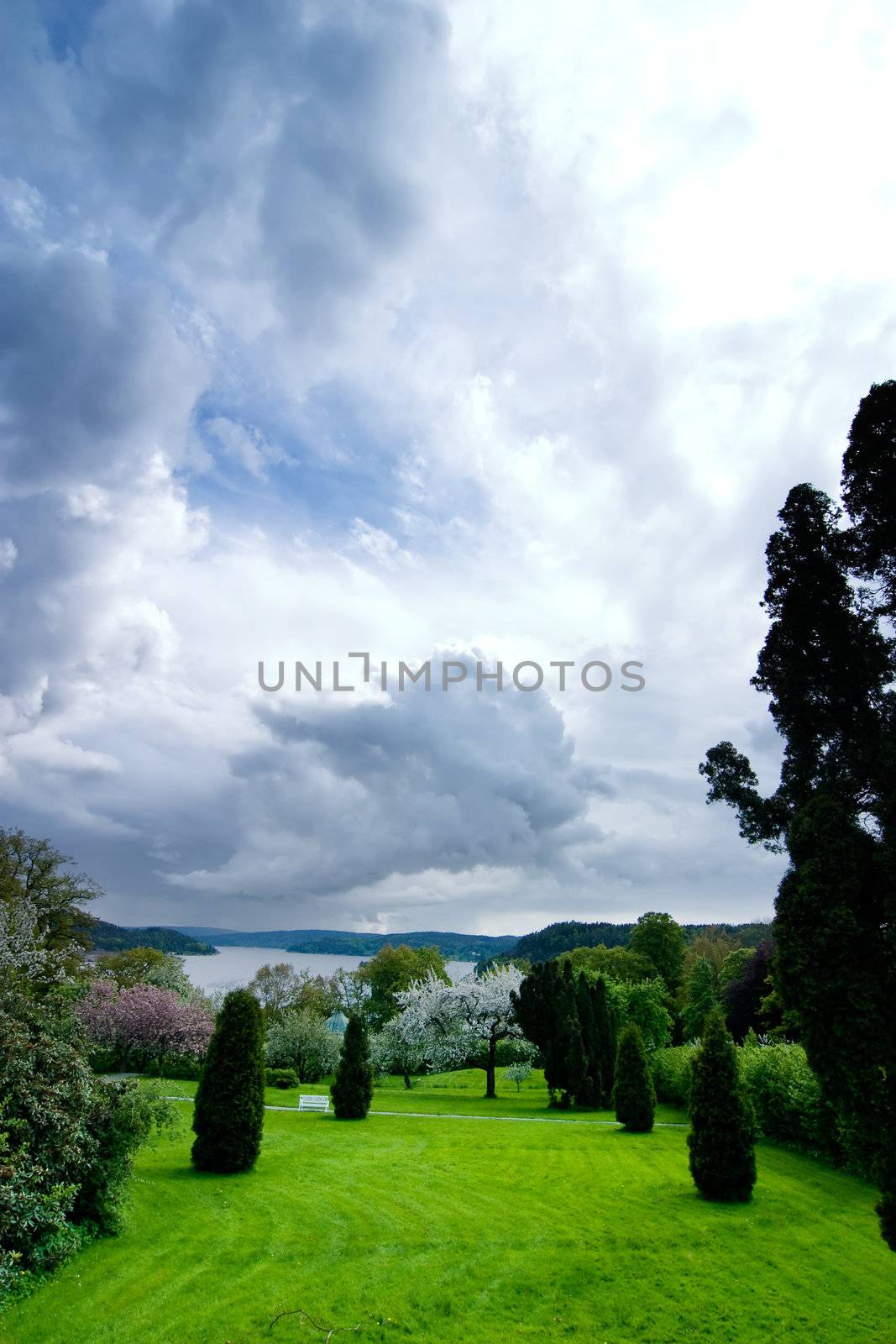 A beautiful park or garden with a dramatic sky in the background