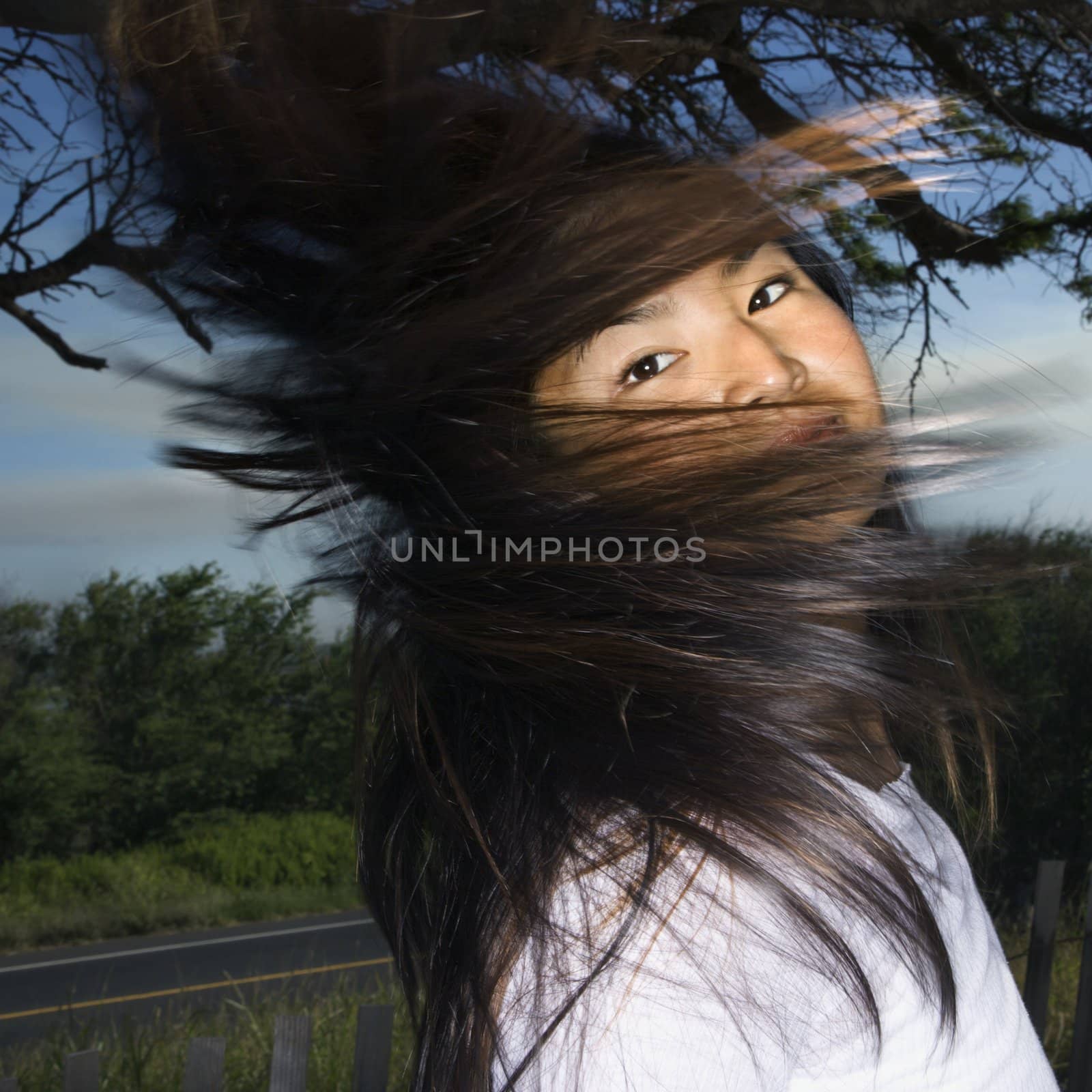 Woman swinging hair. by iofoto