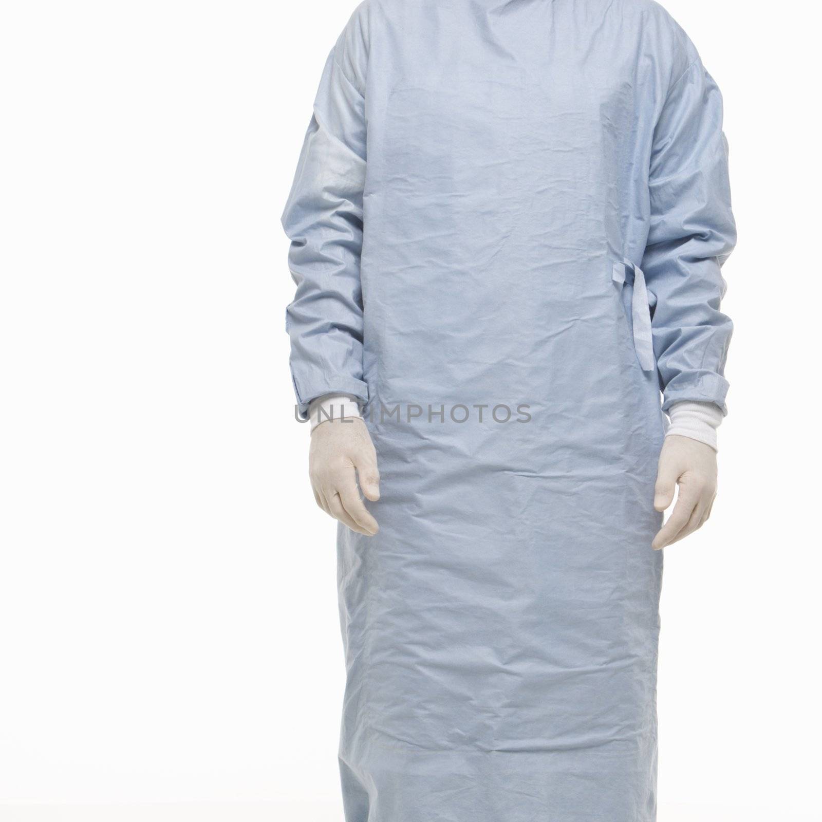 Mid-adult Caucasian male wearing scrubs and medical latex gloves.