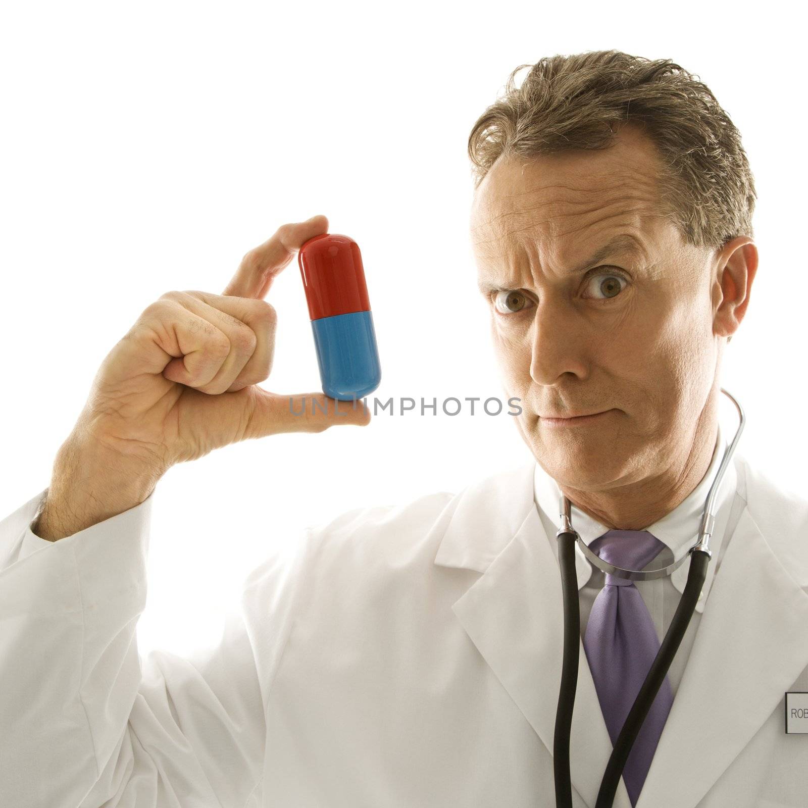 Doctor holding medicine. by iofoto