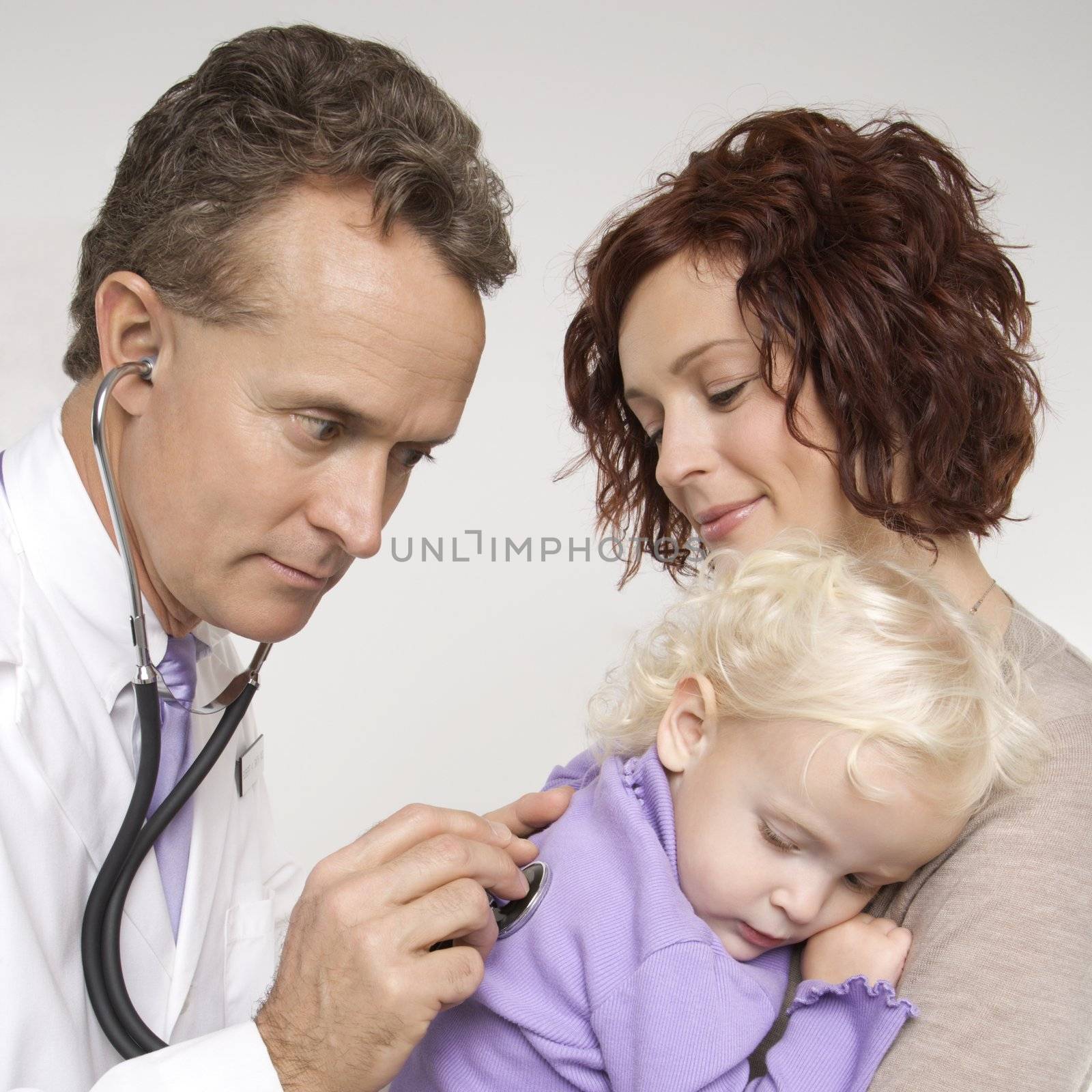 Doctor examining child. by iofoto