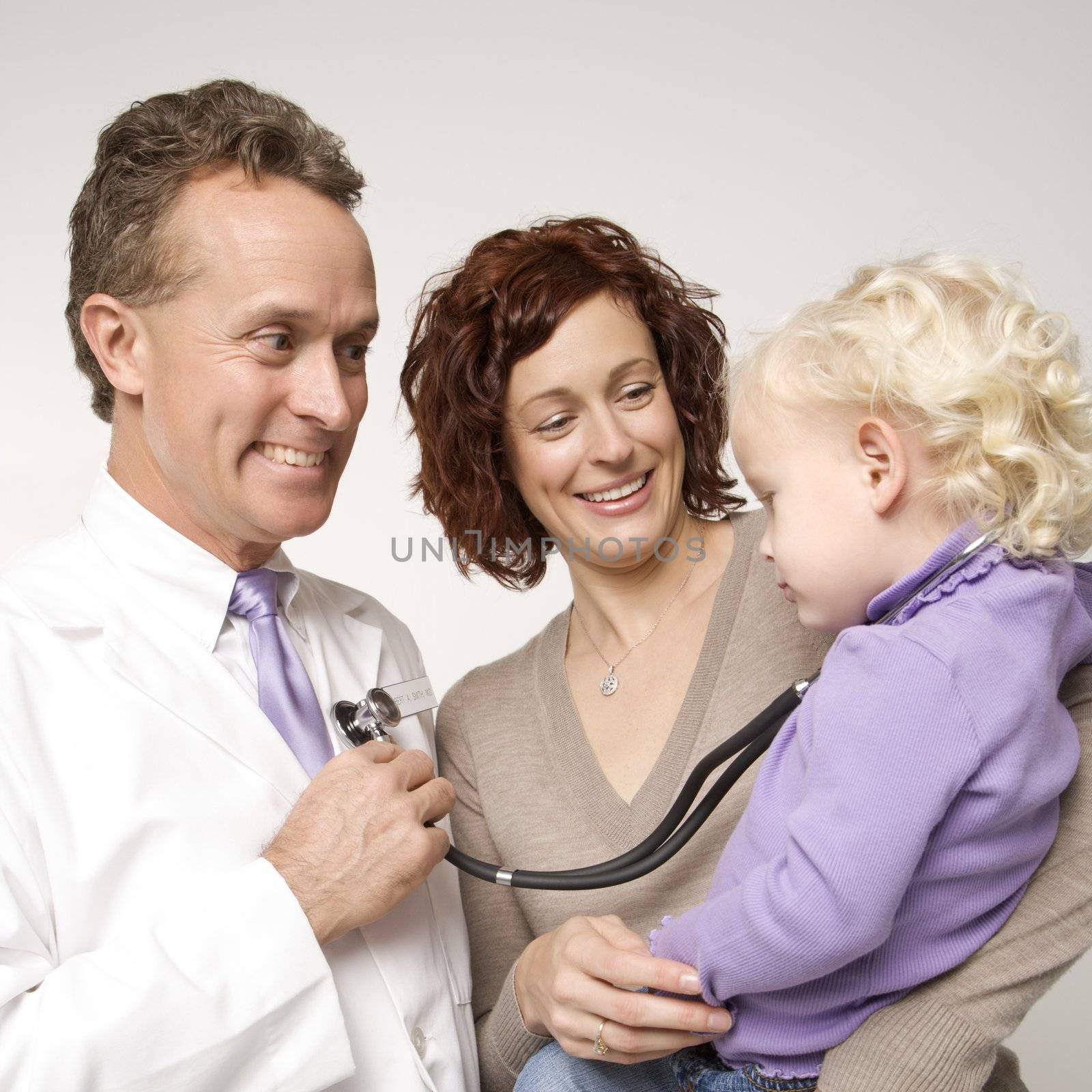 Physician amusing child. by iofoto