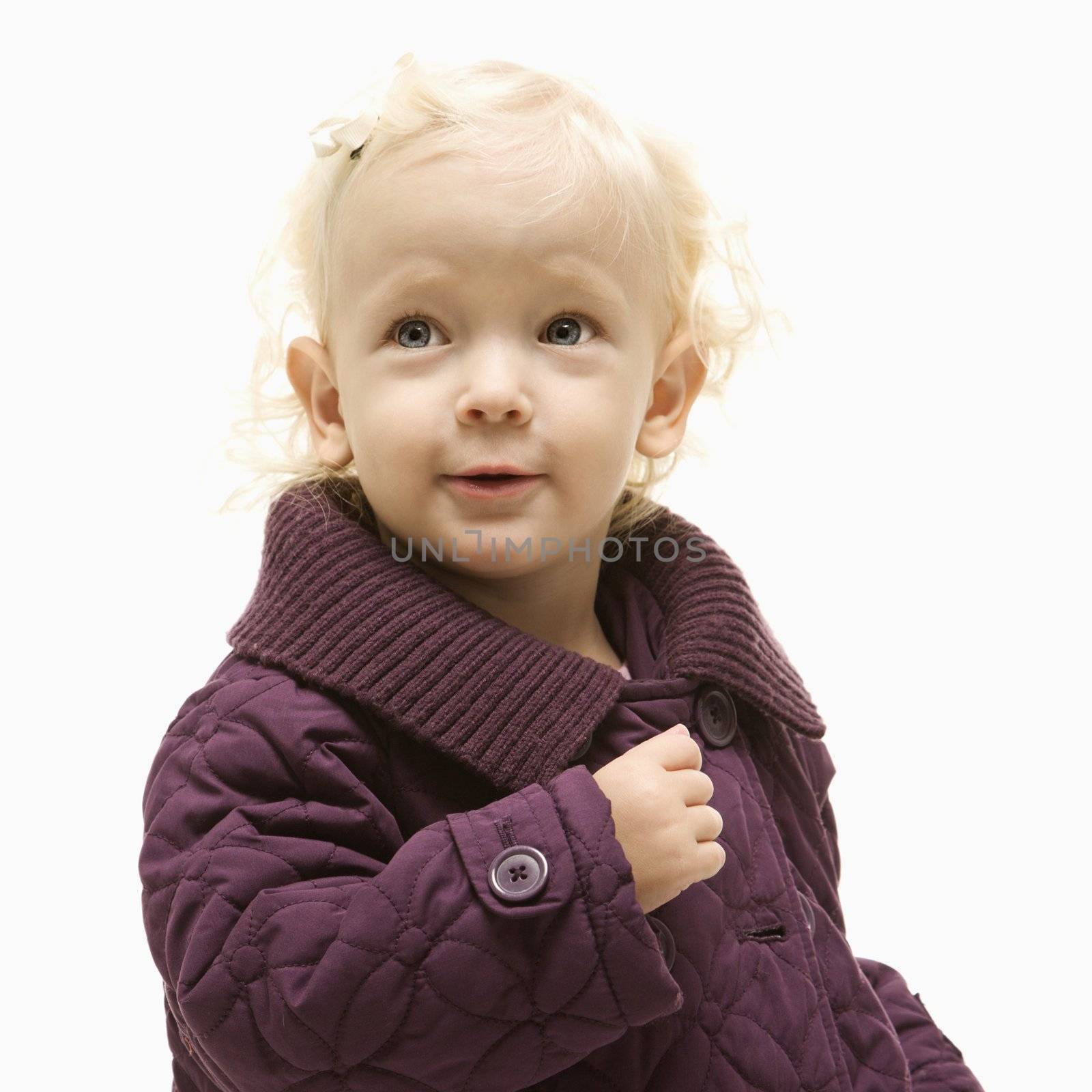 Portrait of young Caucasian female toddler wearing a purple coat.