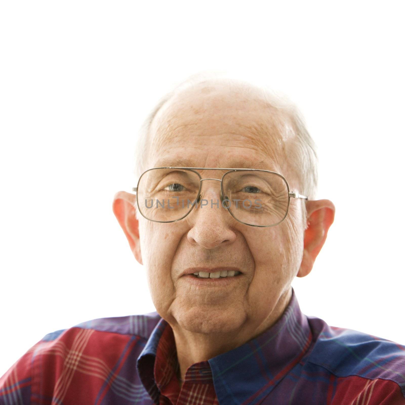 Portrait of smiling Caucasion elderly man in a plaid shirt and glasses.