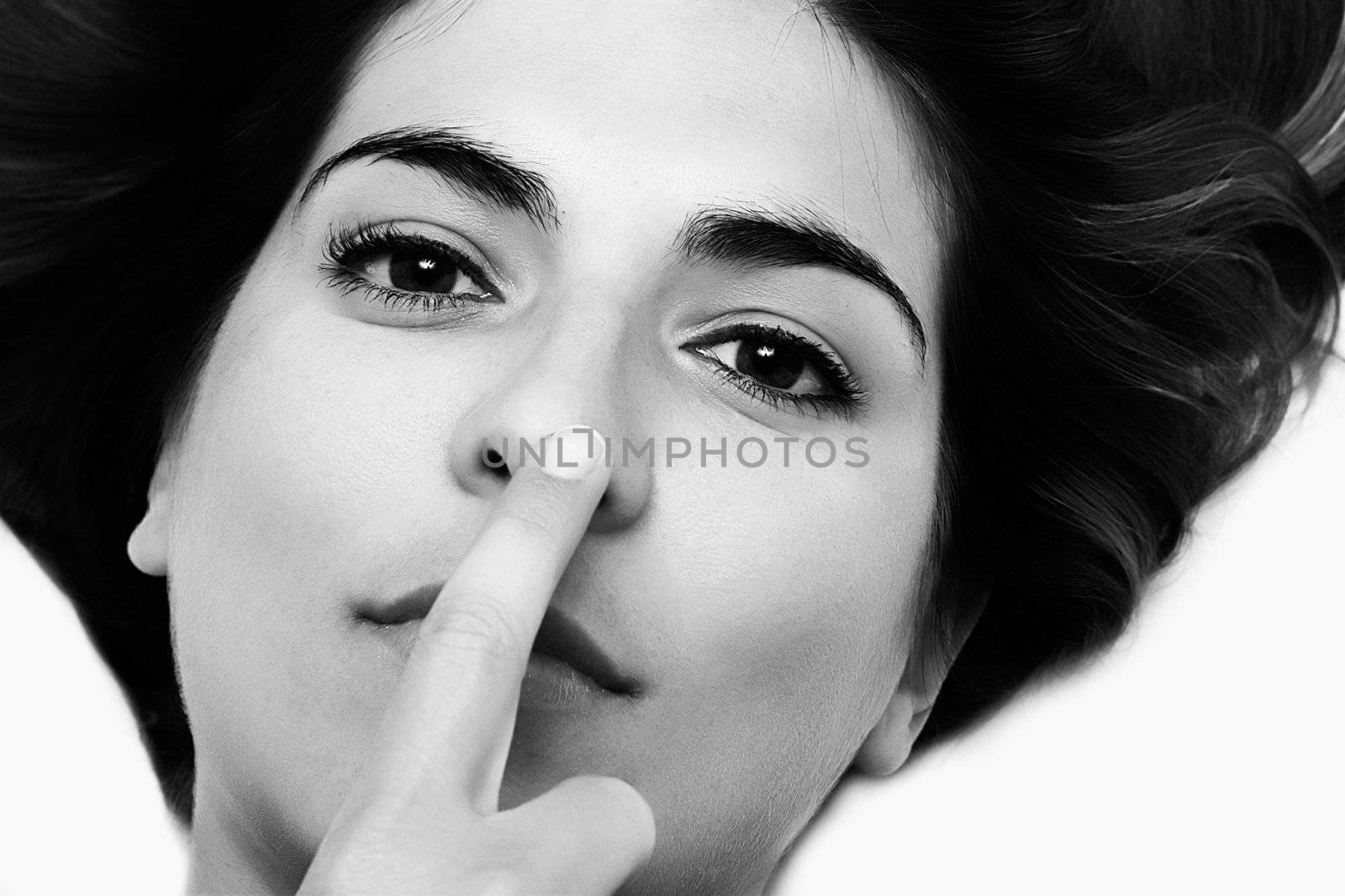 Young woman with the finger on the nose