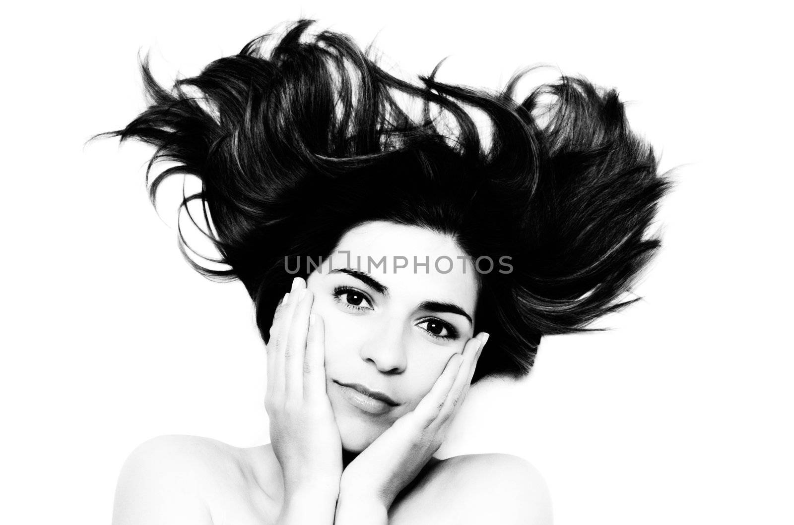 Young woman smiling with hands on the face (BW)