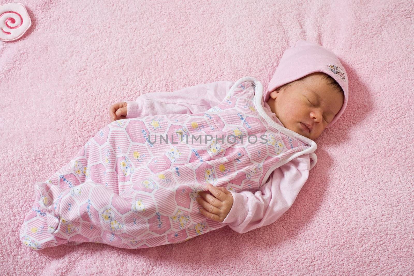 children series: slepping newborn baby in pink color