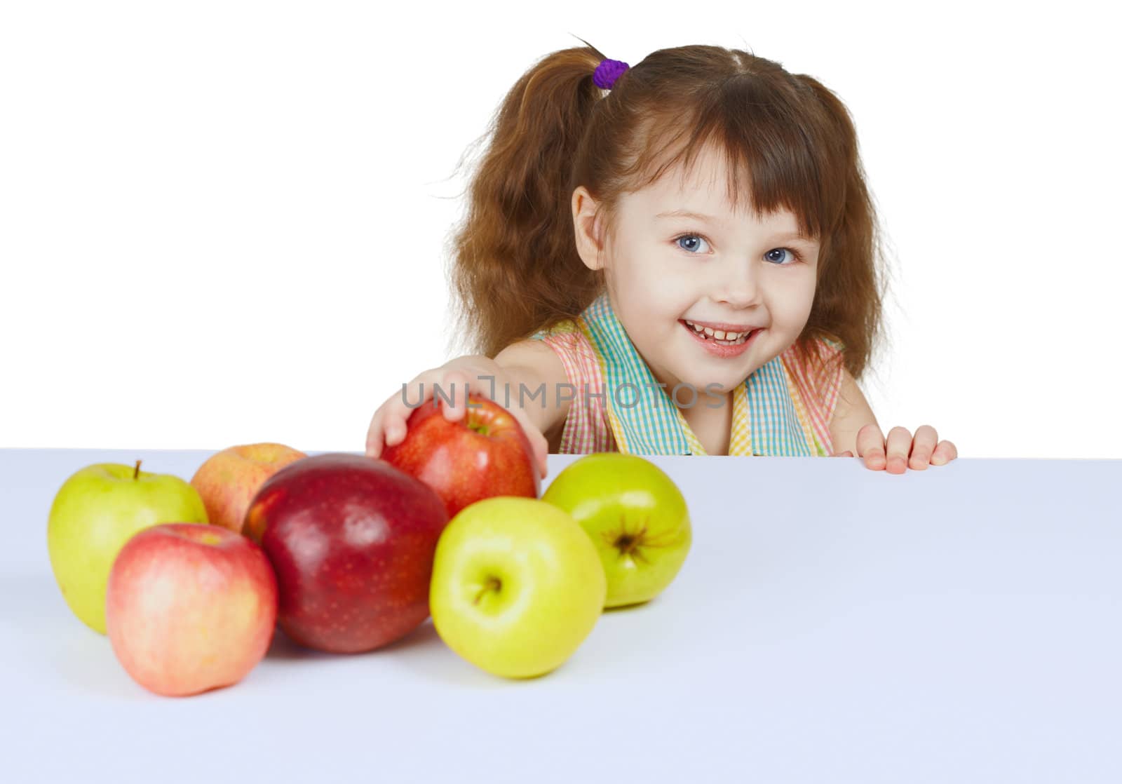 Little cheerful girl with the apples on a white background