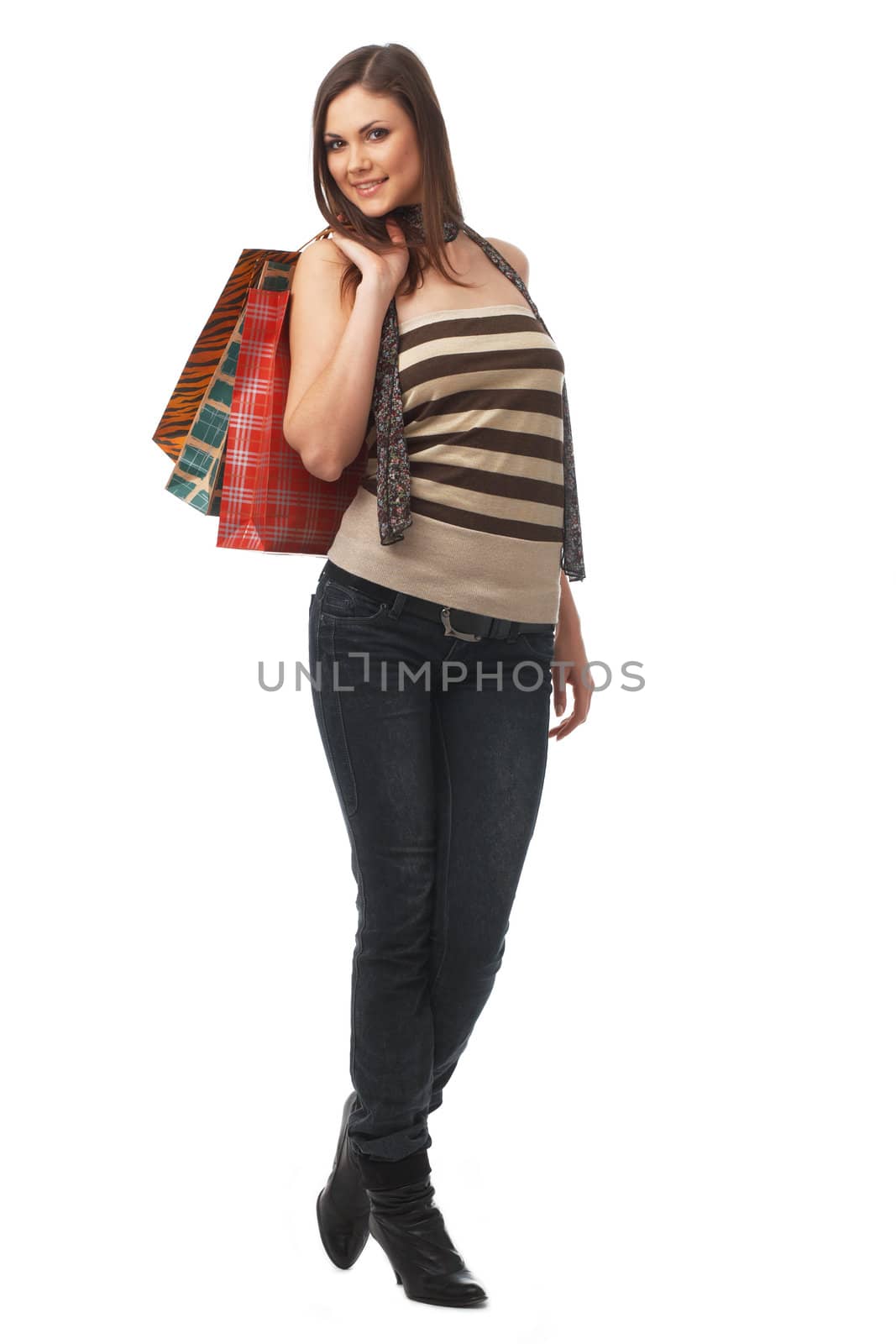 Full length portrait of a young woman with bags over white