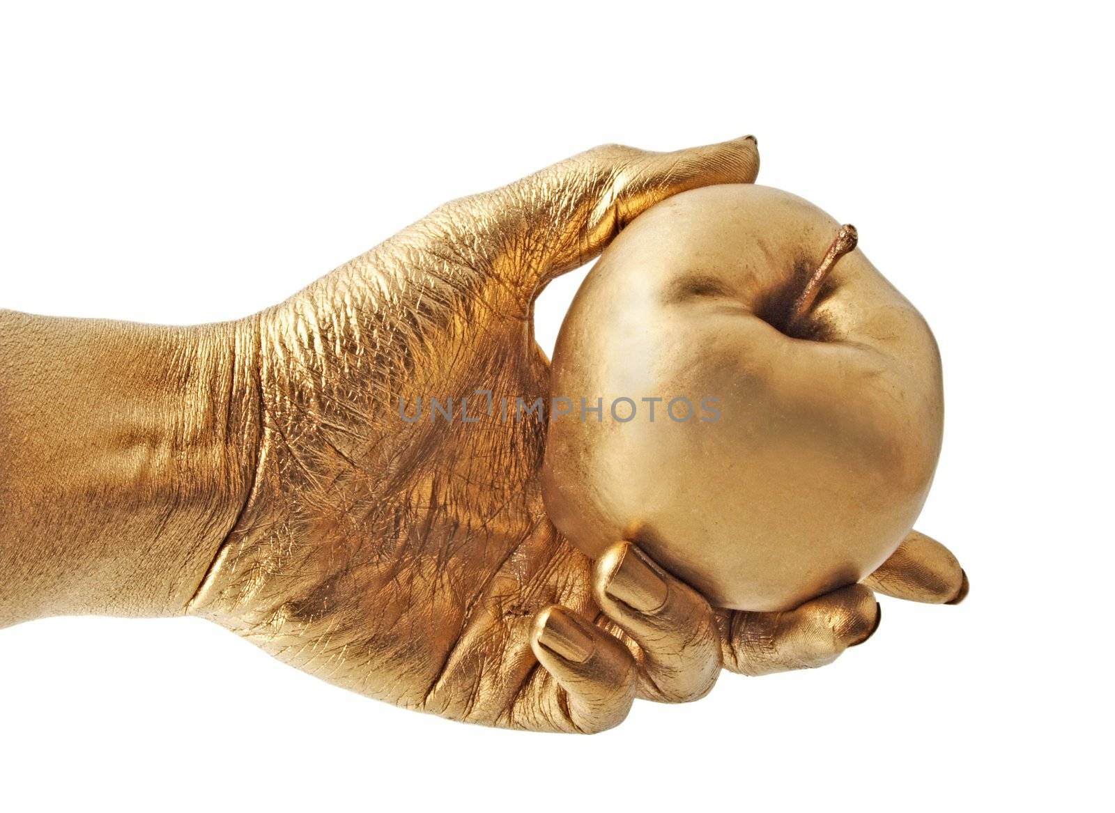 gold hand holding an apple