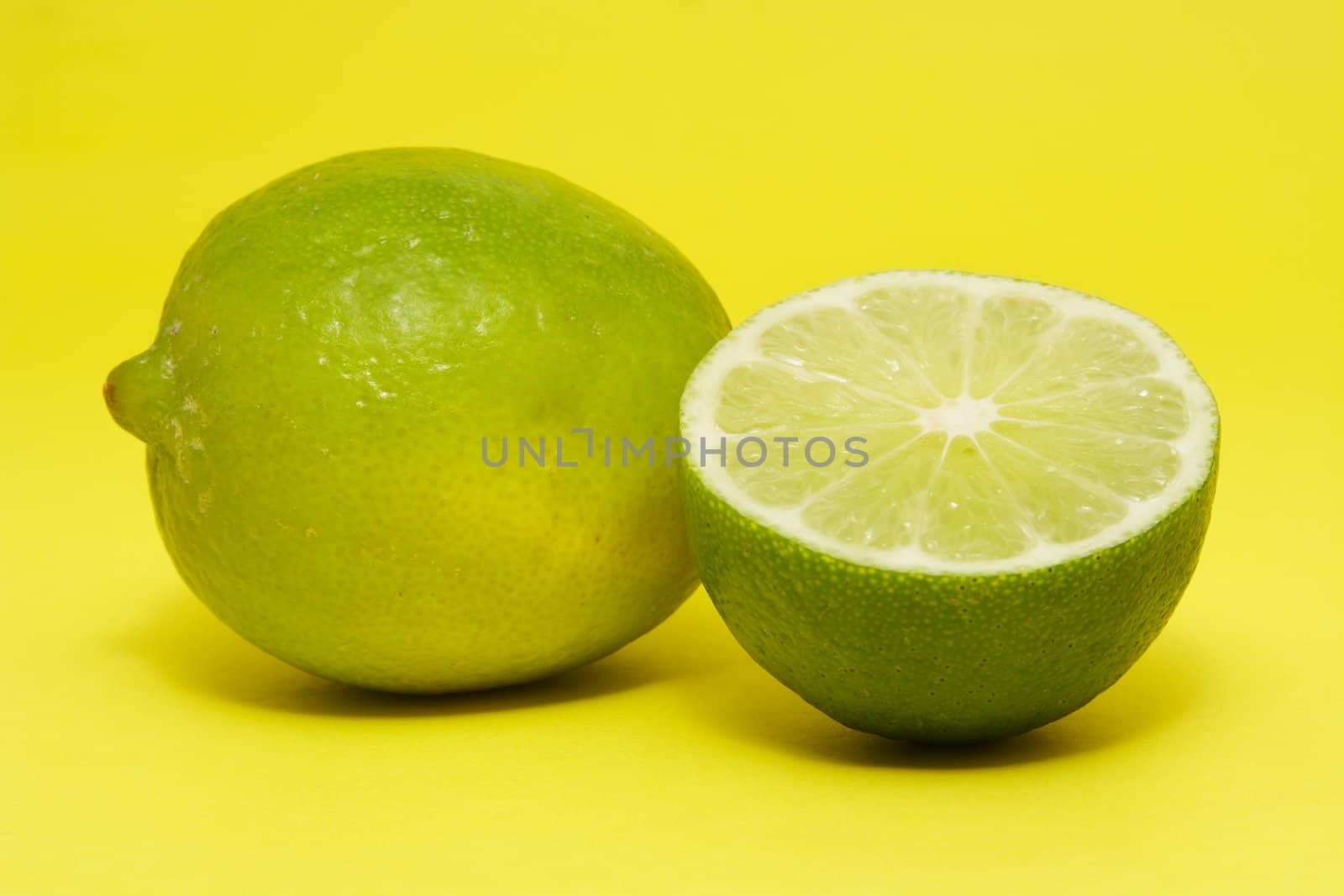 fresh lime on yellow background