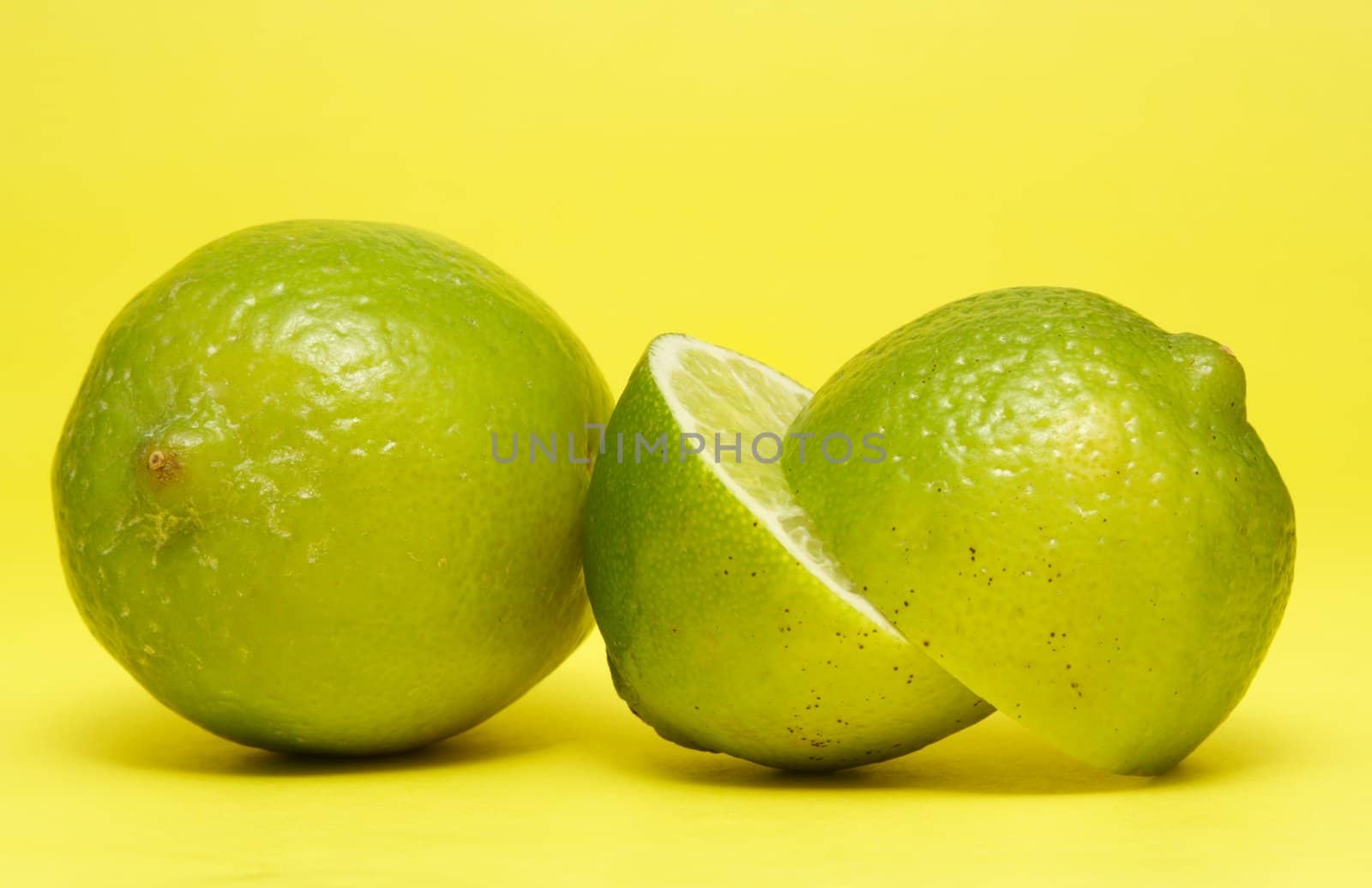 fresh lime on yellow background