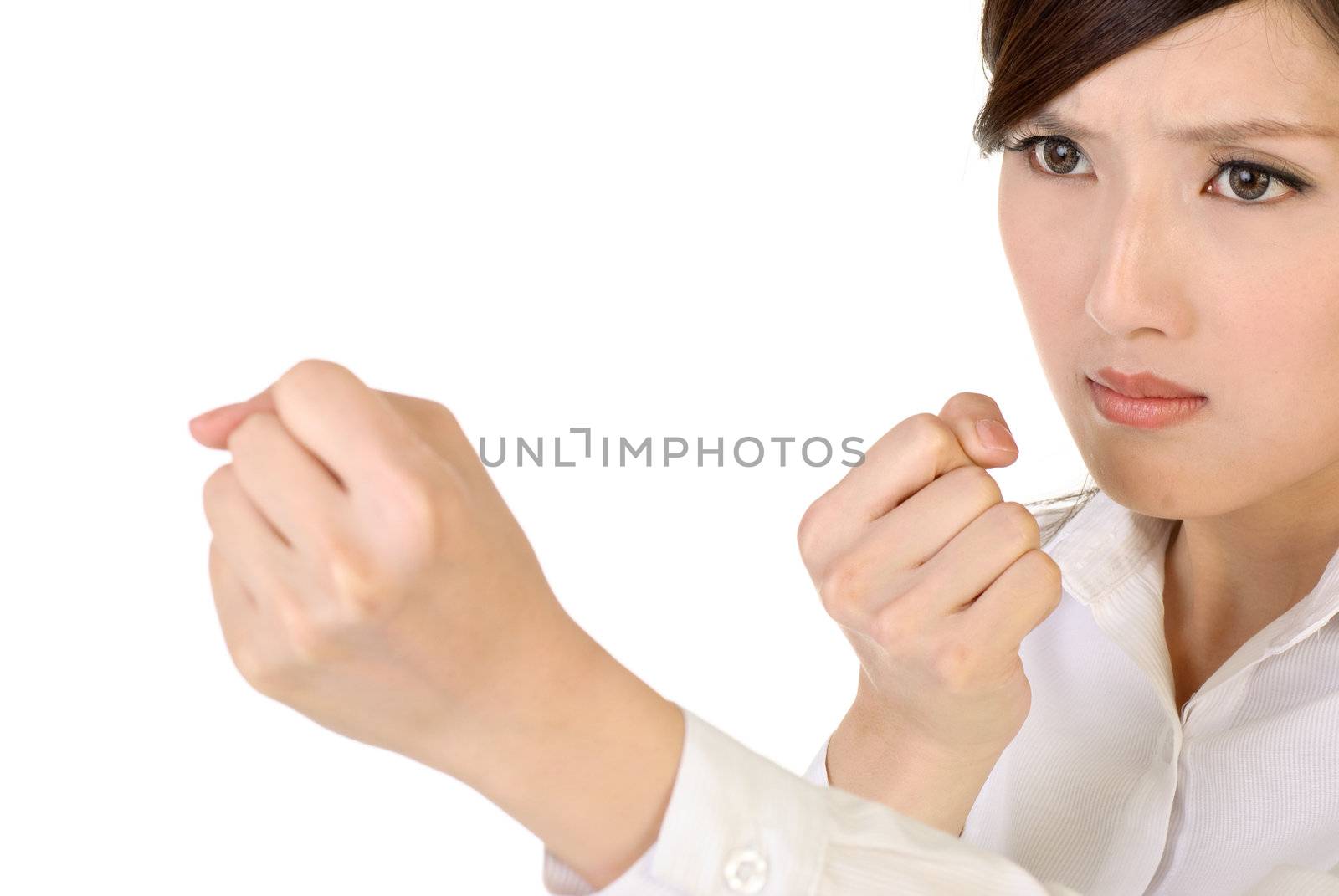 Businesswoman fight pose with confident expression on white background.