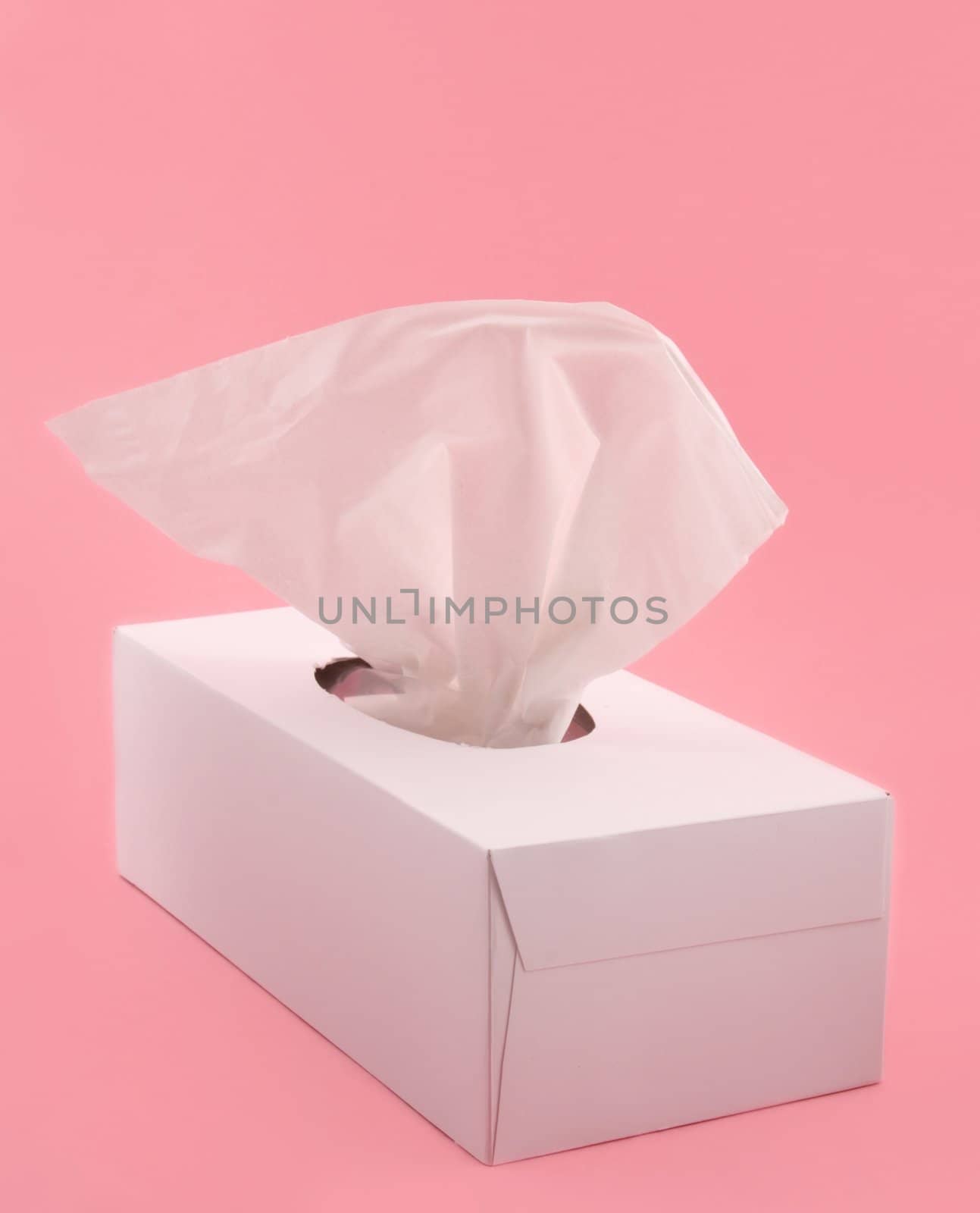 white box of facial tissue on pink background