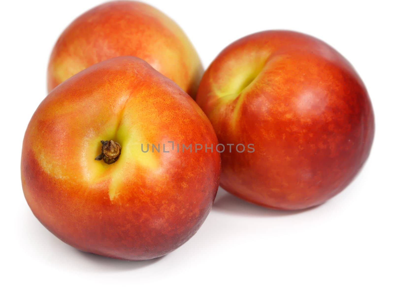 three nectarines isolated on white background