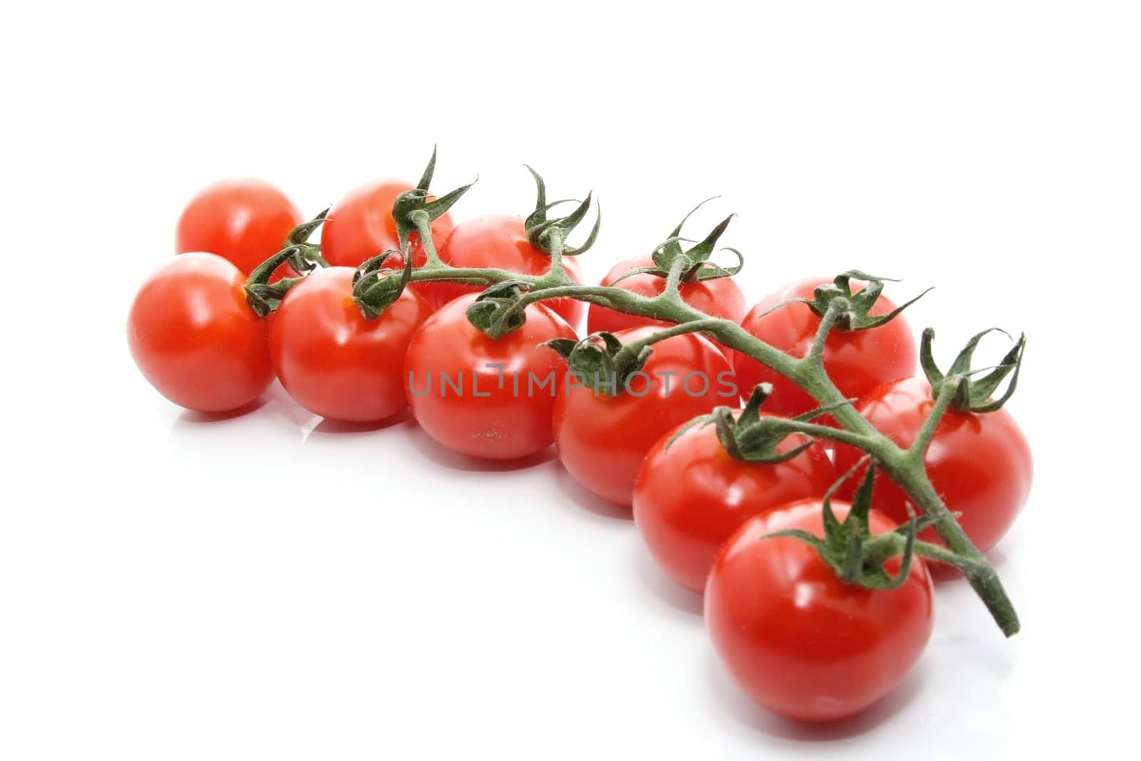 cluster of small tomatoes isolated on white