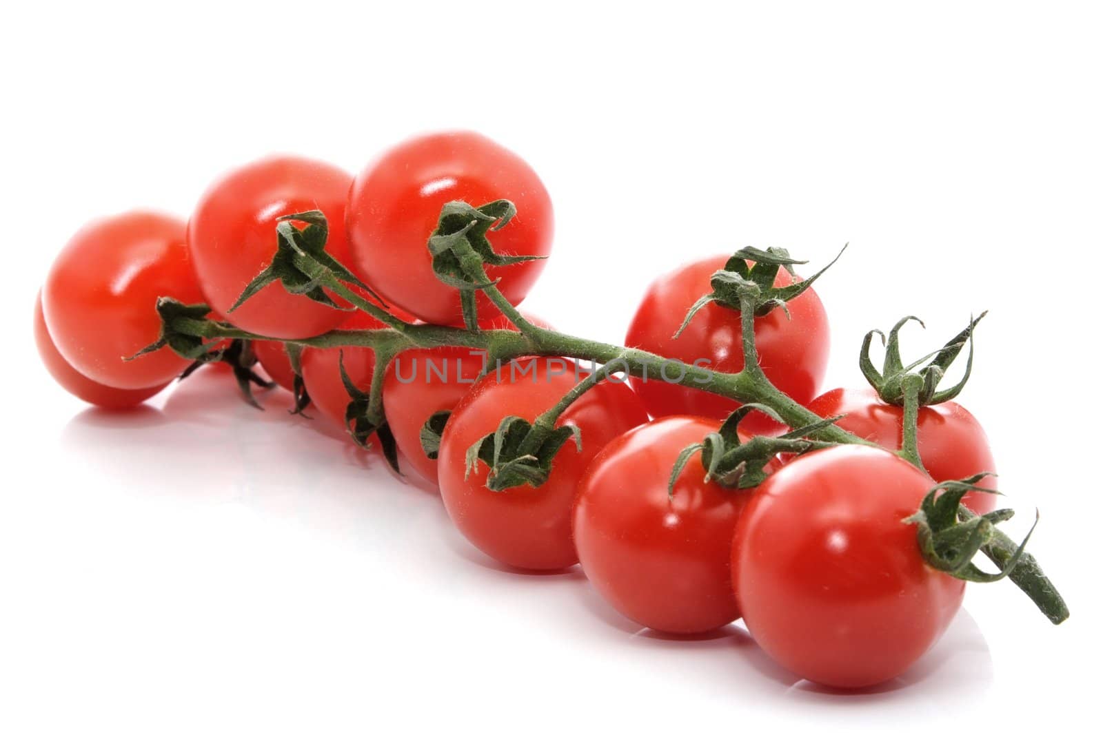 cluster of small tomatoes isolated on white